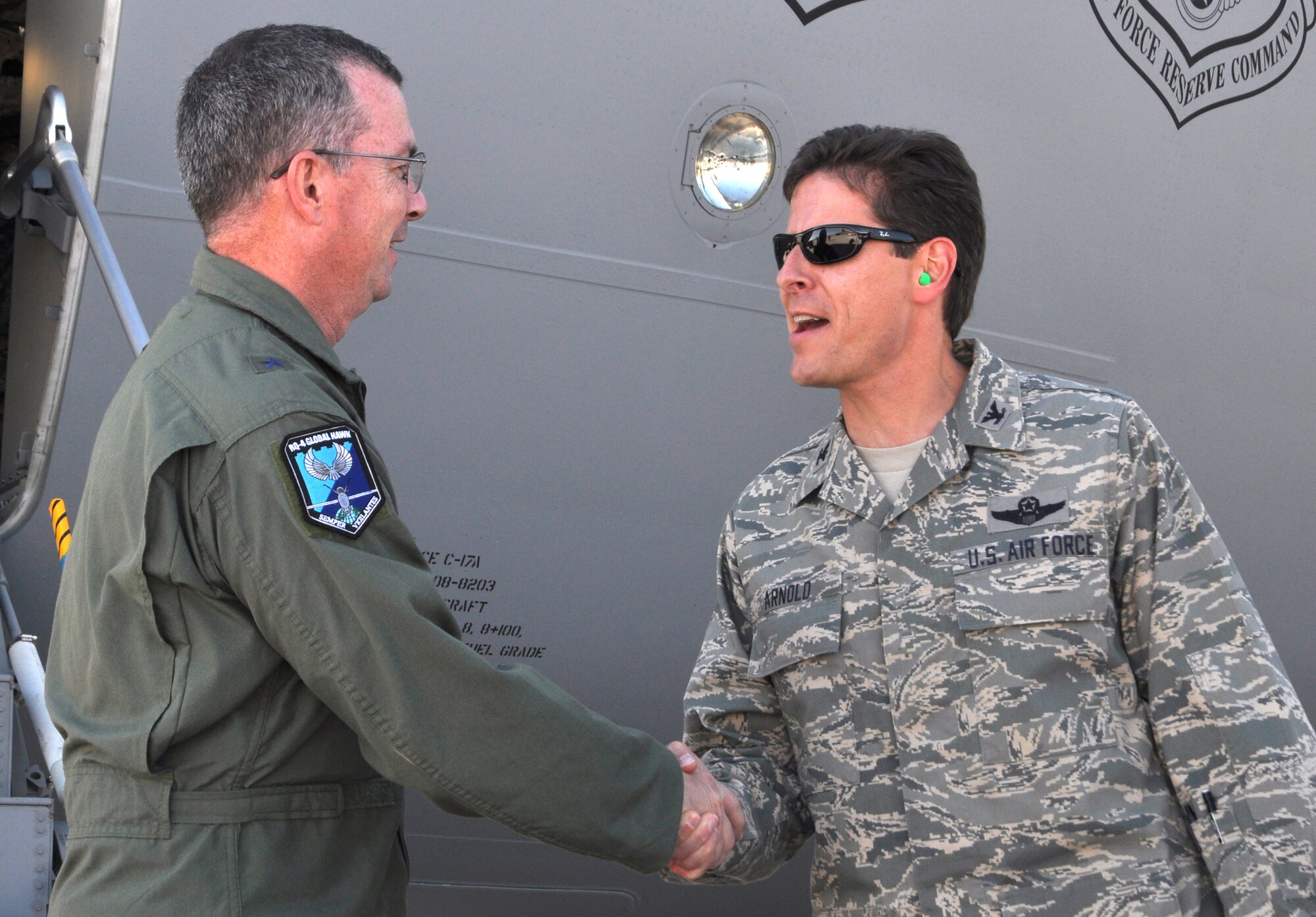 Col. Courtney Arnold (right) shakes the hand of Brig. Gen. Paul McGillicuddy, 9th Reconnaissance Wing commander, upon his arrival Oct. 14 to Peterson Air Force Base, Colo. The general escorted 24 civic leaders from the Yuba County, Calif., area to take part in a joint 940th Wing/9th RW Community Relations Tour to the Colorado Springs area. From Oct. 14-15, the civic leaders were briefed on several missions, including the Air Force Reserve's 302nd Airlift Wing tactical airlift and airdrop and Modular Airborne Firefighting System aerial firefighting missions. The civic leaders also visited U.S. Northern Command, Air Force Space Command and the U.S. Air Force Academy. Air Force-sponsored Community Relations Tours allow community and civic leaders to gain a better perspective on how the Air Force Reserve and its Active Duty counterparts work together. Colonel Arnold is the 302nd AW vice commander. (U.S. Air Force photo/Staff Sgt. Stephen J. Collier)