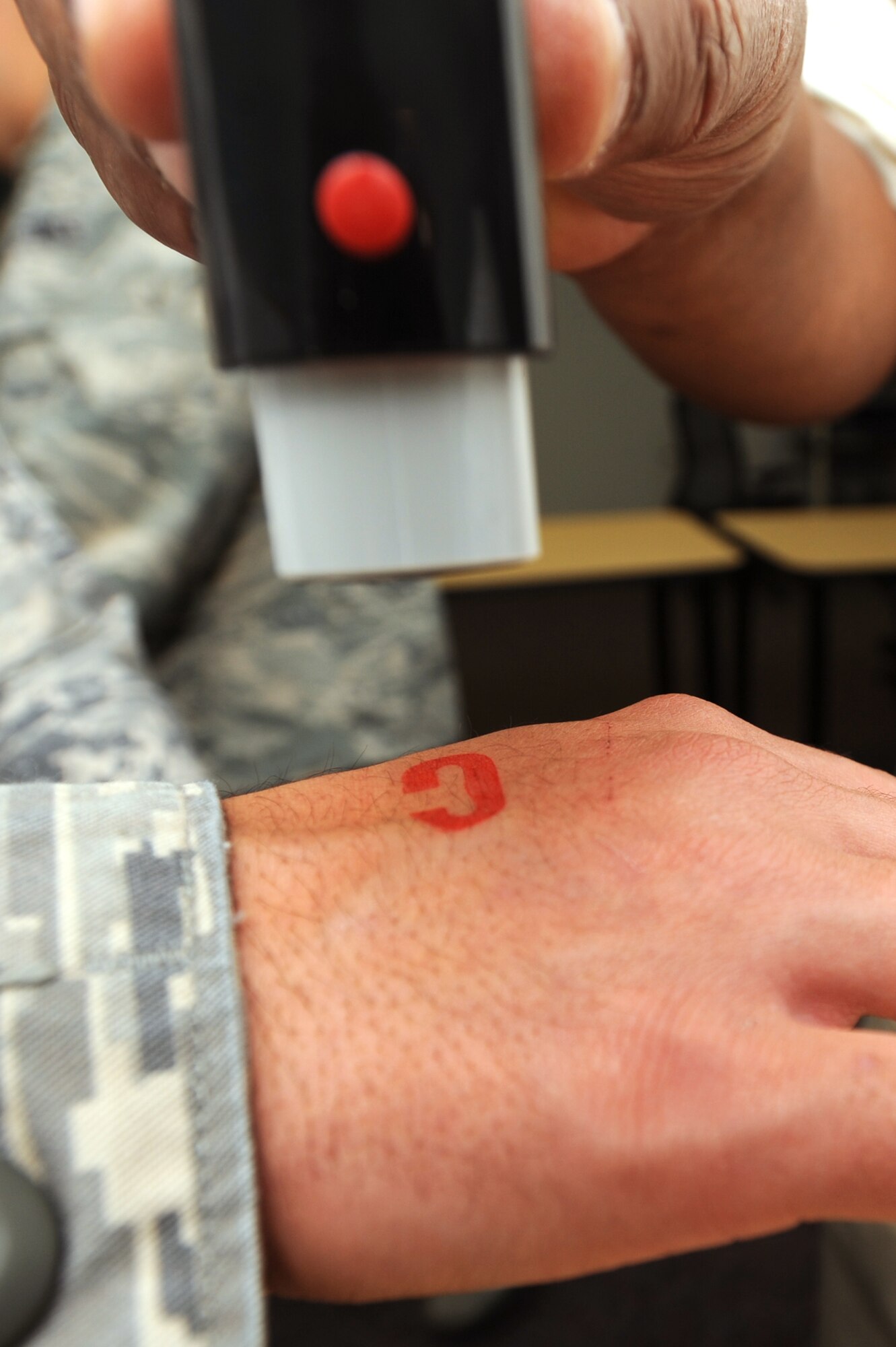 WHITEMAN AIR FORCE BASE, Mo.- The 509th Medical Group stamps a "C" for Cleared on a simulated patient during a disease containment exercise, Oct. 13. The exercise evaluated the 509th MDG's processes to contain the spread of the bubonic and pneumonic plagues, treatment procedures for contaminated patients, and medication needed to cure the patients.(U.S. Air Force photo by Senior Airman Carlin Leslie)
