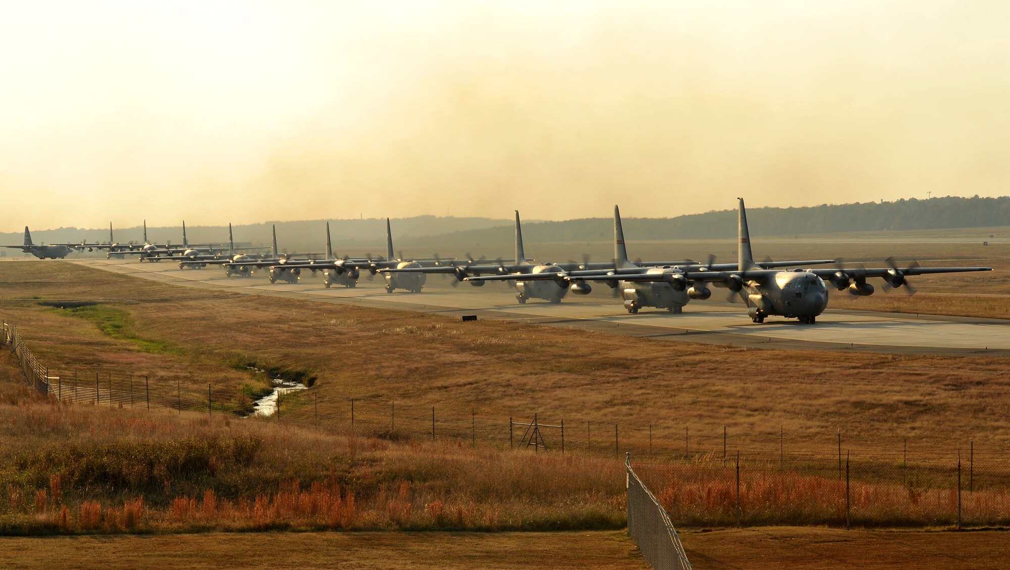 C-130 Hercules aircraft taxi down the base runway Oct. 18 to take part in a Joint Readiness Training Center exercise. In the joint exercise with the Army, 26 C-130s will fly to Alexandria International Airport in Alexandria, La., to pick up approximately 1,700 Army paratroopers of the 82nd Airborne Division's 3rd Brigade and tons of cargo from Fort Bragg, N.C. (U.S. Air Force photo by Staff Sgt. Chris Willis)