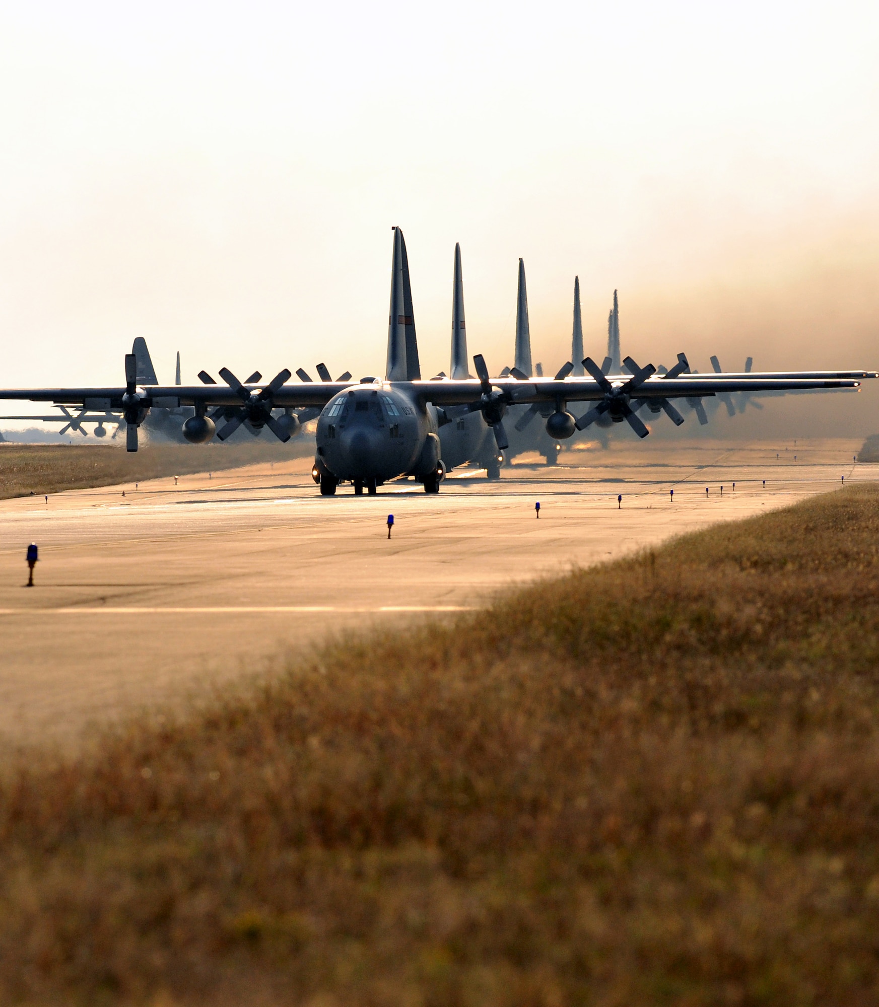C-130 Hercules aircraft taxi down the base runway Oct. 18 to take part in a Joint Readiness Training Center exercise. In the joint exercise with the Army, 26 C-130s will fly to Alexandria International Airport in Alexandria, La., to pick up approximately 1,700 Army paratroopers of the 82nd Airborne Division's 3rd Brigade and tons of cargo from Fort Bragg, N.C. (U.S. Air Force by Senior Airman Gul Crockett)