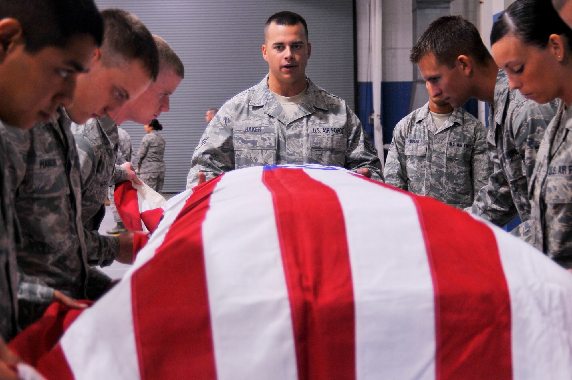 Airman 1st Class Justin Baker, Mobile Training Team superintendent, oversees Hurlburt Field and Eglin Honor Guard Airmen perform a body bearer movement. This training was part of a two-week course to standaridized Honor Guard movements and sequences Air Force-wide. (DoD photo by Air Force Senior Airman Sheila DeVera, released)