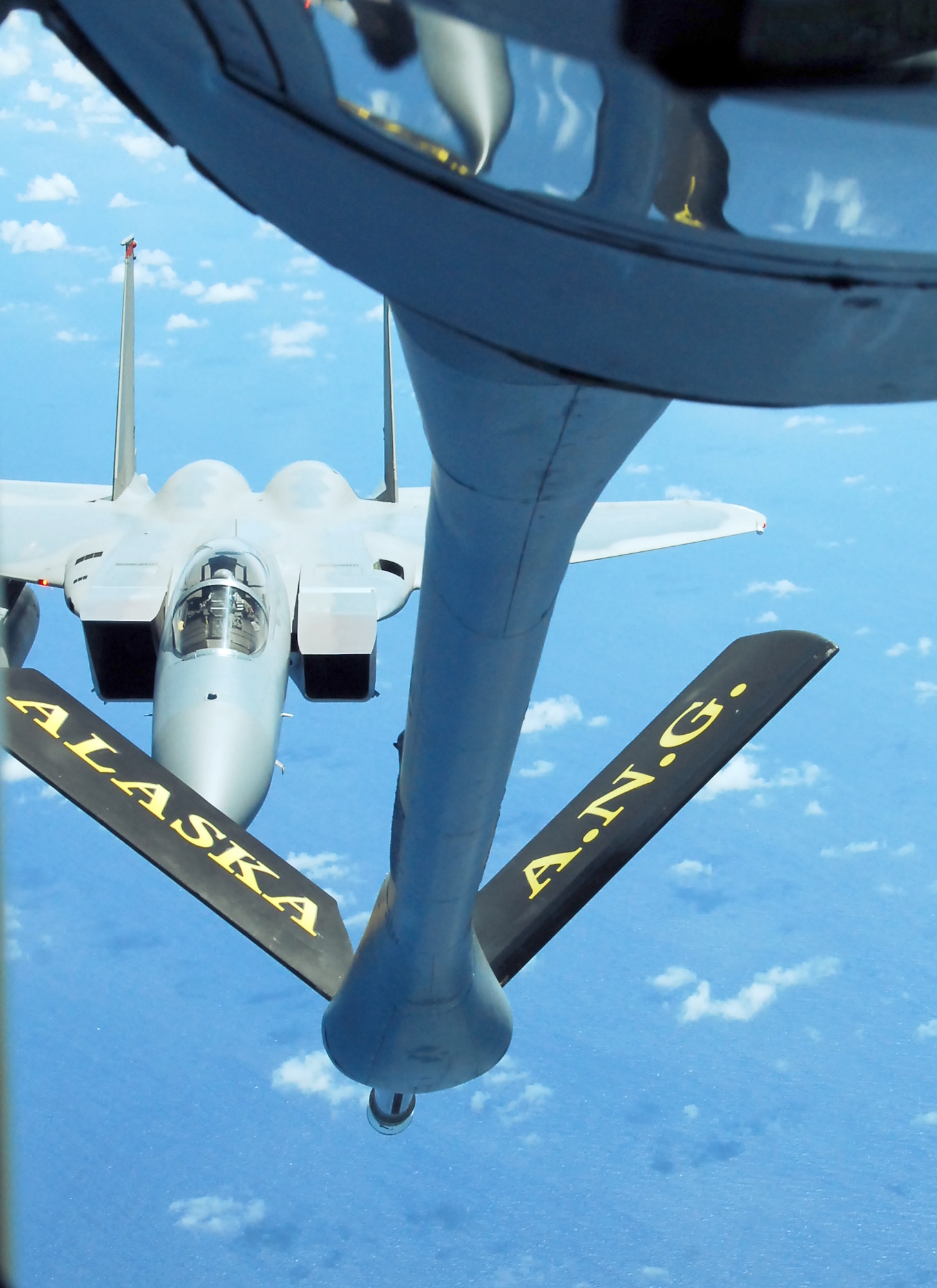 Members of the 506th Expeditionary Air Refueling Squadron perform a midair refueling mission on an F-15 Strike Eagle Oct. 14, 2010, over the Pacific Ocean. The 168th ARW is deployed to Andersen Air Force Base, Guam in support of the continuous bomber presence and theater security packages in the Pacific region. The 506th EARS is an Air National Guard unit deployed to Andersen AFB from the 168th Air Refueling Wing, Alaska. (U. S. Air Force photo/Airman Whitney Amstutz)