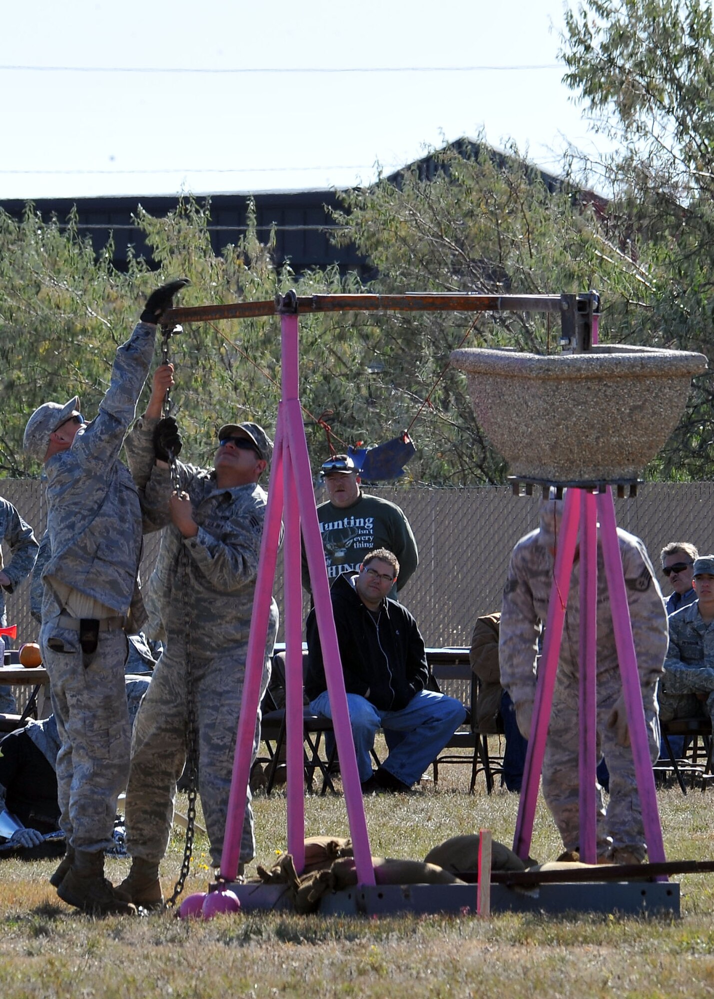 MINOT AIR FORCE BASE, N.D. -- Air Force Global Strike Command Airmen from the 5th Civil Engineer Squadron, prepare their makeshift trebuchet for launch here Oct. 14. The annual pumpkin throwing contest, hosted by 5th CES, provides an opportunity for Airmen to be creative in a competitive setting that instills unit cohesion in hopes of receiving the golden pumpkin trophy. (U.S. Air Force photo by Senior Airman Michael J. Veloz)