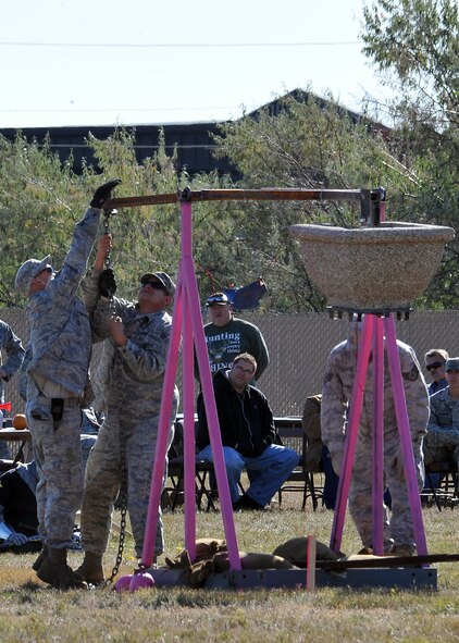 MINOT AIR FORCE BASE, N.D. -- Air Force Global Strike Command Airmen from the 5th Civil Engineer Squadron, prepare their makeshift trebuchet for launch here Oct. 14. The annual pumpkin throwing contest, hosted by 5th CES, provides an opportunity for Airmen to be creative in a competitive setting that instills unit cohesion in hopes of receiving the golden pumpkin trophy. (U.S. Air Force photo by Senior Airman Michael J. Veloz)