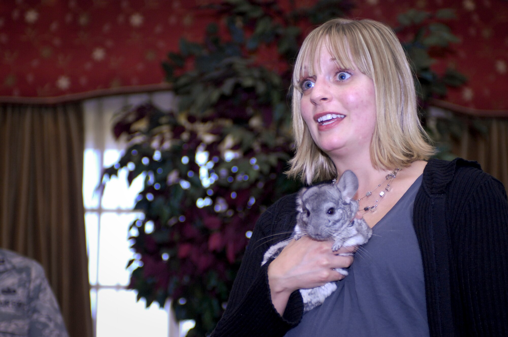 MINOT AIR FORCE BASE, N.D. -- Becky Dewitz, Roosevelt Park Zoo education coordinator, talks with members of the Military Affairs Committee at their monthly luncheon about different educational opportunities the zoo facilitates with the help of her chinchilla at the Jimmy Doolittle Center here Oct. 14. The MAC holds a monthly luncheon to discuss topics regarding the base and local communities. (U.S. Air Force photo by Senior Airman Benjamin Stratton)
