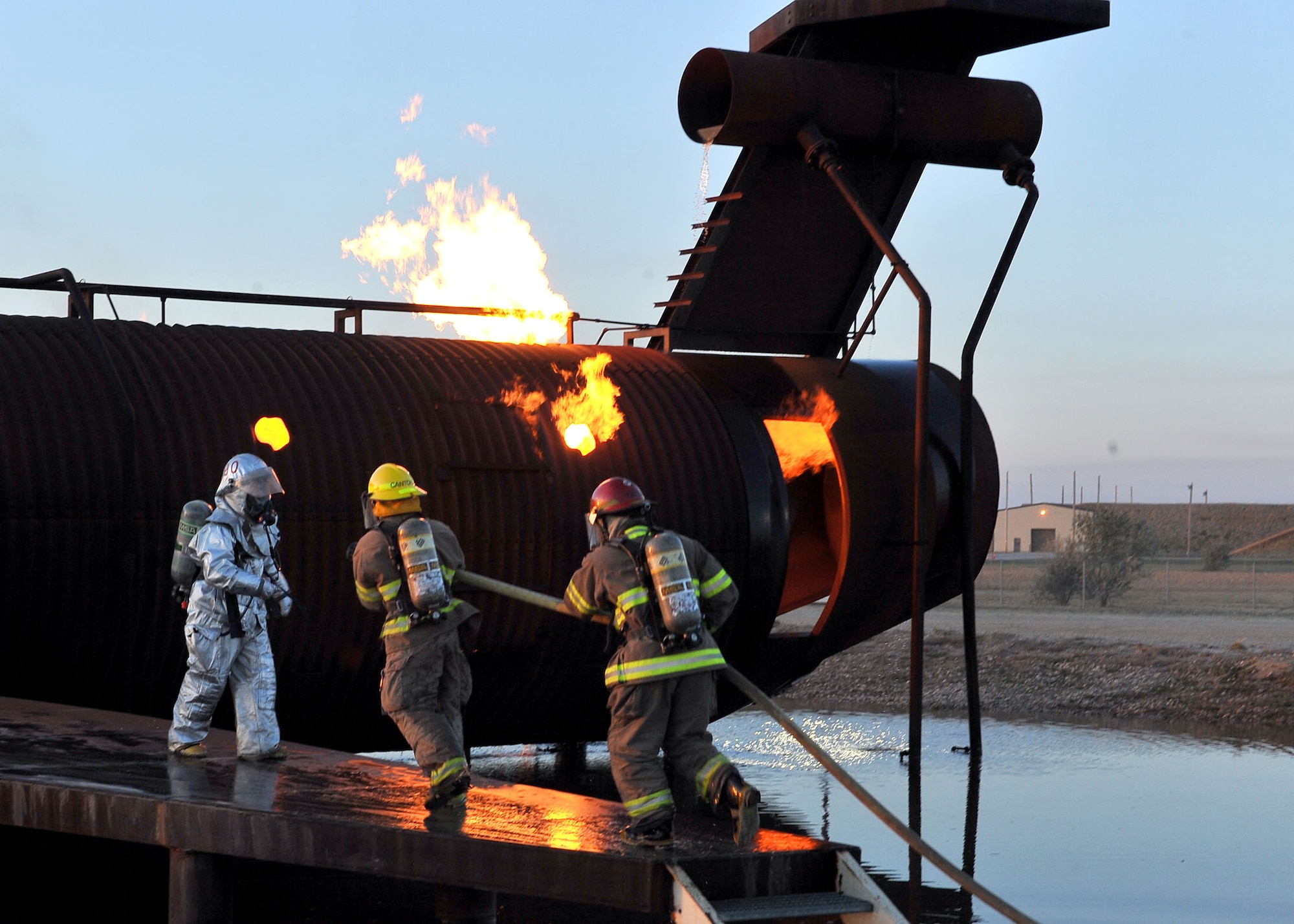 MINOT AIR FORCE BASE, N.D. -- Air Force Global Strike Command Airmen from the 5th Civil Engineer Squadron fire department, team up with the City of Minot fire department during live fire training here Oct. 14. This annual training requirement helps keep both fire departments sharp in their capabilities to save lives in the face of danger. (U.S. Air Force photo by Senior Airman Michael J. Veloz)