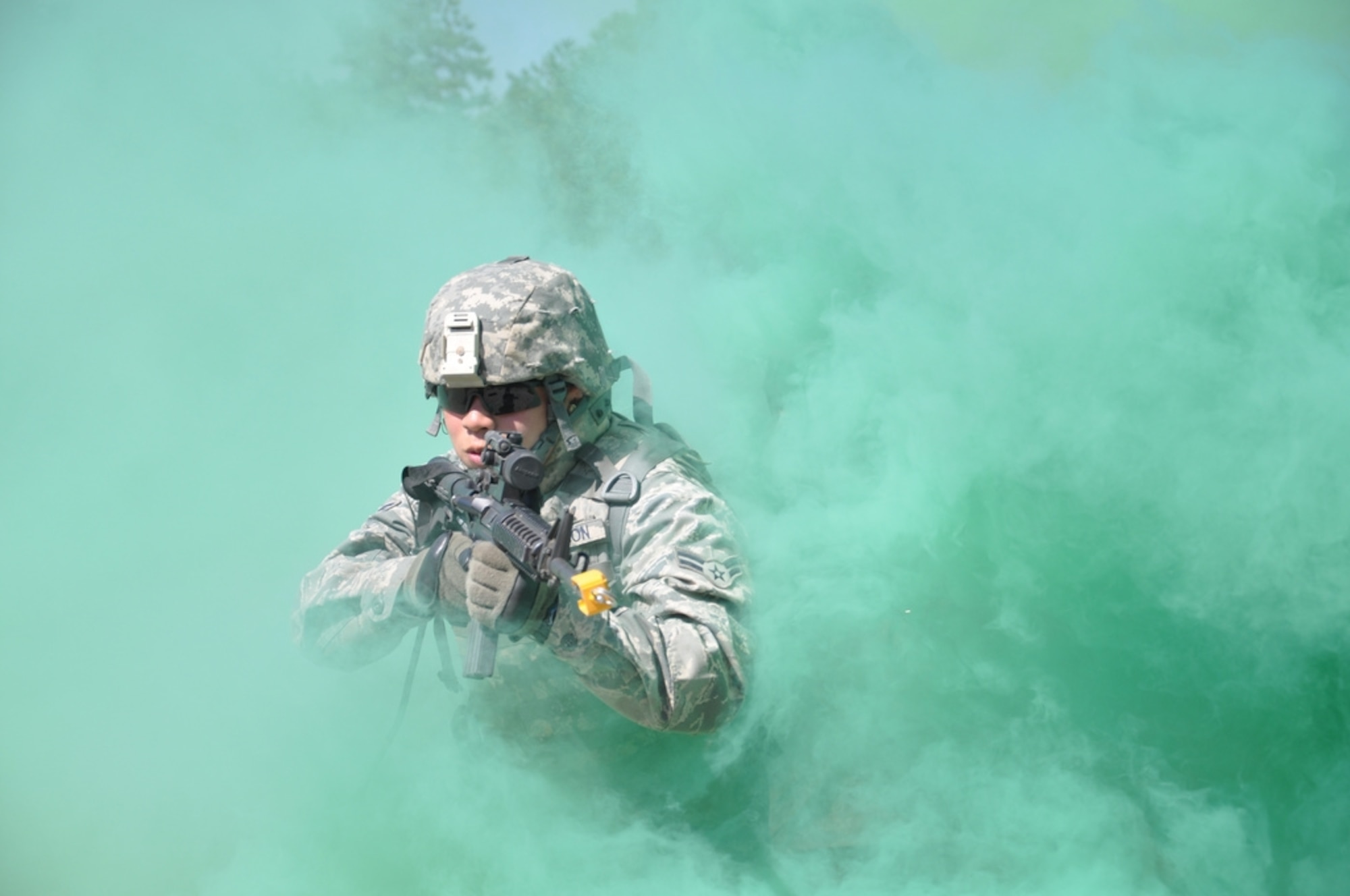 Airman 1st Class John Fallesgon, 633rd Force Support Squadron food services chef at Langley Air Force Base, Va., peers through the smoke to engage enemy during a foot patrol at Combat Skills Training here Sept. 2. The 602nd Training Group (P) Detachment 6 produces approximately 2,400 joint expeditionary tasking Airmen each year. (U.S. Air Force photo/Chief Master Sgt. David Richards)