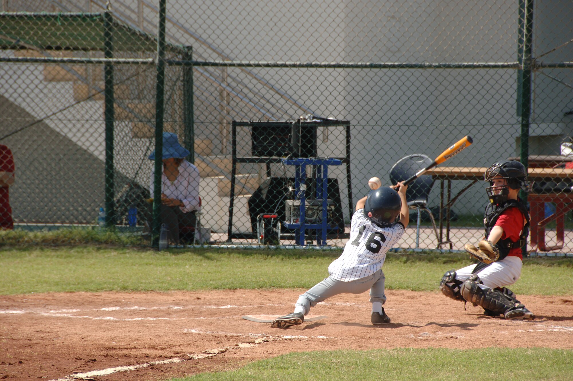 SOUTHWEST ASIA - A player from the Mariners takes a hit for a walk during his first game of the season here Oct. 15 agains the Nationals. Kids from more than 20 different nationalities play American baseball at our host nation's American High School. (U.S. Air Force photo/Tech. Sgt. Kimberly Spinner)