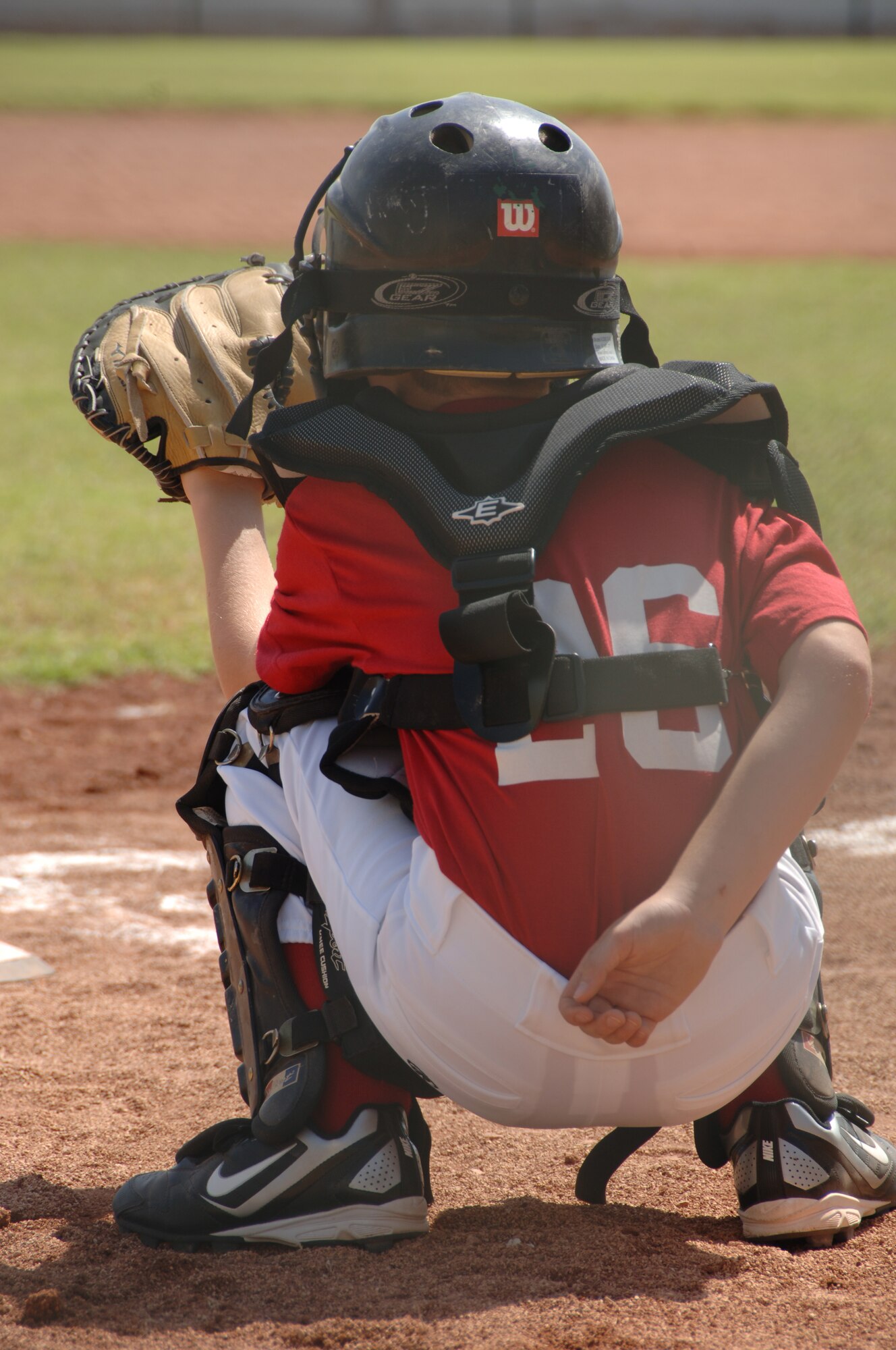 SOUTHWEST ASIA - A catcher plays in first game of the season here Oct. 15. Kids from more than 20 different nationalities play American baseball at our host nation's American High School. (U.S. Air Force photo/Tech. Sgt. Kimberly Spinner)