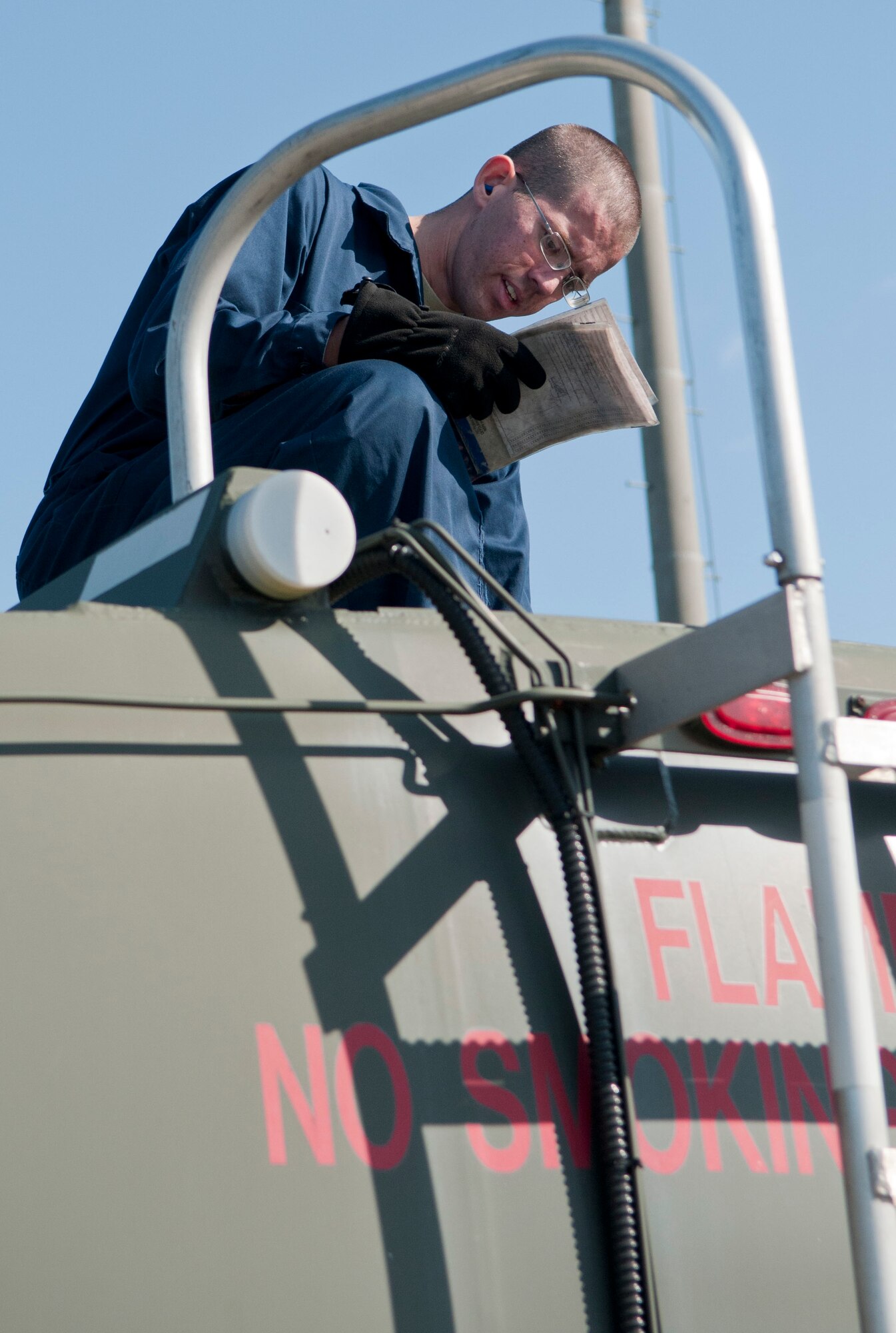Airman 1st Class Daniel Westerfield, 35th Logistic Readiness Squadron refueling maintenance technician, checks his technical order while performing a fuel truck inspection at Misawa Air Base, Japan, Oct. 19, 2010, during a Logistics Compliance Assessment Program inspection. Fuels Airmen inspect each of the squadron’s 20 fuel trucks before being serviced on the flightline. (U.S. Air Force photo by Senior Airman Jessica Lockoski/Released)