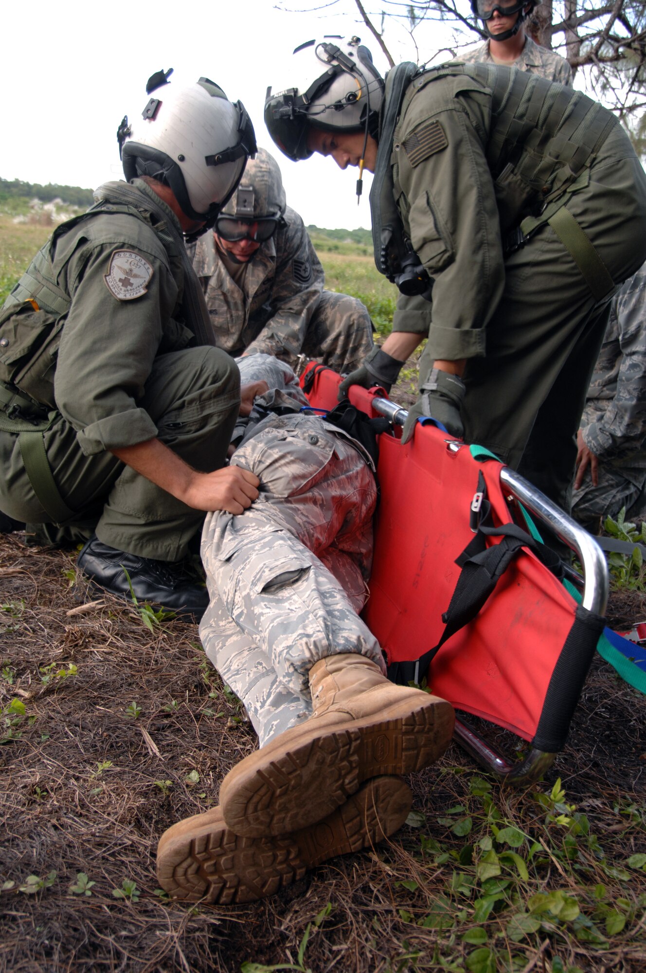 Servicemembers assigned to the 36th Mobility Response Squadron and Helicopter Sea Combat Squadron TWENTY-FIVE conduct 9-Line Medical Evacuation training at Northwest Field Oct. 13. The joint field training exercise was performed in an effort to interchange and familiarize themselves with each other?s tactics, techniques and procedures to be able to interoperate and conduct joint Humanitarian Assistance/Disaster Relief missions in the Pacific region. (U.S. Air Force photo/Airman 1st Class Anthony Jennings)