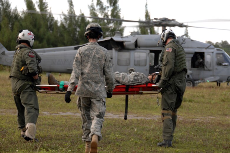 Servicemembers assigned to the 36th Mobility Response Squadron and HSC-25 conduct 9-Line Medical Evacuation training at Northwest Field Oct. 13. The joint field training exercise was performed in an effort to interchange and familiarize themselves with each other?s tactics, techniques and procedures to be able to interoperate and conduct joint Humanitarian Assistance/Disaster Relief missions in the Pacific region. (U.S. Air Force photo/Airman 1st Class Anthony Jennings)
