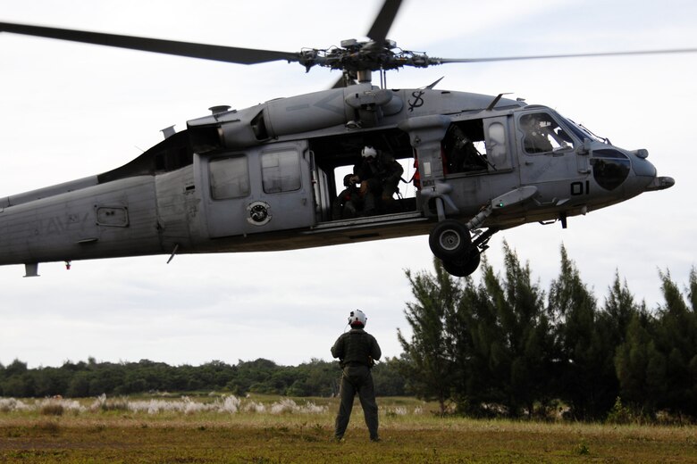 Servicemembers assigned to the 36th Mobility Response Squadron and HSC-25 conduct 9-Line Medical Evacuation training at Northwest Field Oct. 13. The joint field training exercise was performed in an effort to interchange and familiarize themselves with each other?s tactics, techniques and procedures to be able to interoperate and conduct joint Humanitarian Assistance/Disaster Relief missions in the Pacific region. (U.S. Air Force photo/Airman 1st Class Anthony Jennings)