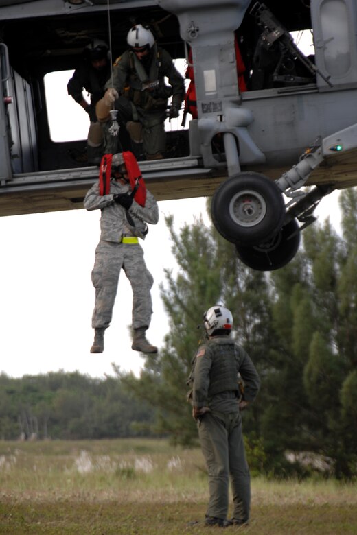 Servicemembers assigned to the 36th Mobility Response Squadron and HSC-25 conduct 9-Line Medical Evacuation training at Northwest Field Oct. 13. The joint field training exercise was performed in an effort to interchange and familiarize themselves with each other?s tactics, techniques and procedures to be able to interoperate and conduct joint Humanitarian Assistance/Disaster Relief missions in the Pacific region. (U.S. Air Force photo/Airman 1st Class Anthony Jennings)