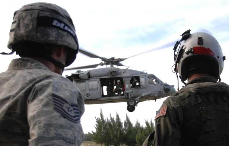 Servicemembers assigned to the 36th Mobility Response Squadron and HSC-25 conduct 9-Line Medical Evacuation training at Northwest Field Oct. 13. The joint field training exercise was performed in an effort to interchange and familiarize themselves with each other?s tactics, techniques and procedures to be able to interoperate and conduct joint Humanitarian Assistance/Disaster Relief missions in the Pacific region. (U.S. Air Force photo/Airman 1st Class Anthony Jennings)