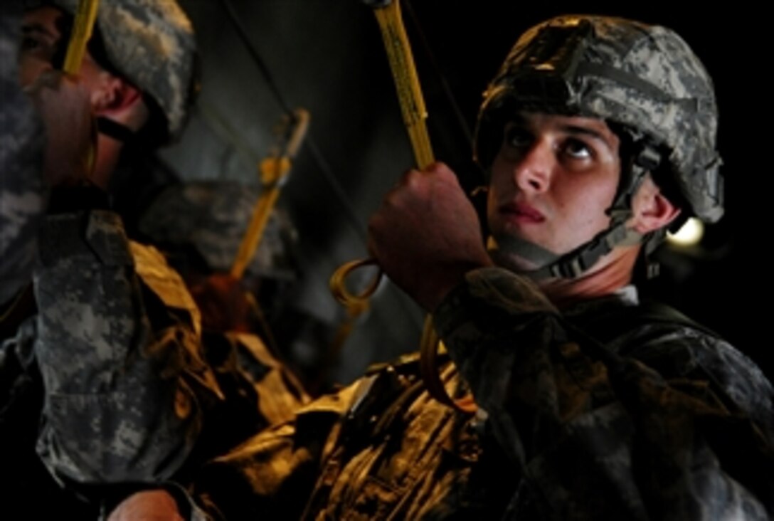 U.S. Army paratroopers assigned to the 1st Battalion, 505th Parachute Infantry Regiment prepare to conduct an airborne insertion from a C-130 Hercules aircraft assigned to Little Rock Air Force Base, Ark., during a joint forcible entry exercise at Pope Air Force Base, N.C., on Sept. 12, 2010.  A joint forcible entry exercise is a large-scale heavy equipment and troop movement exercise conducted by the Air Force and the Army.  