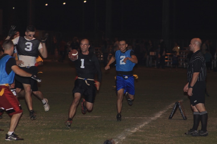 Steve Debruyn, the Ultimate Warriors quarterback, sprints with ease for a touchdown during the Ultimate Warriors vs. Bloodbath and Beyond 2010 Intramural Flag Football game at Penny Lake field here Oct. 20. The Ultimate Warriors played tough defense, made sustained drives and completed passes, which landed them a 26 - 14 victory over Bloodbath and Beyond.