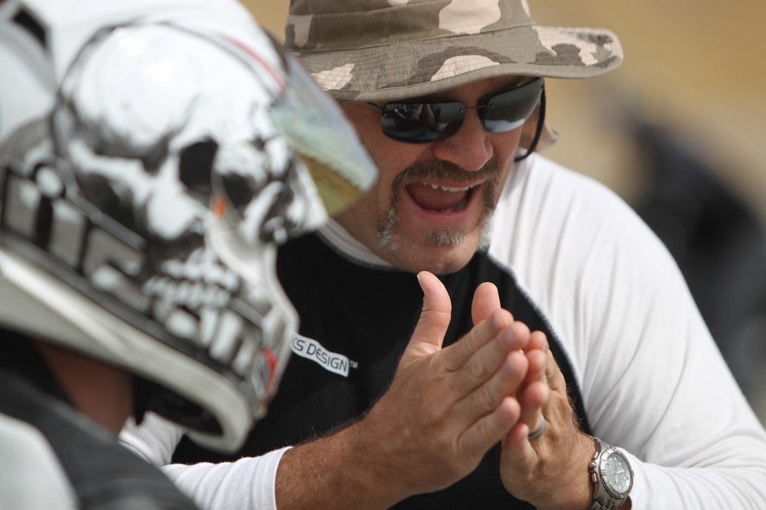 Wayne Miller, an instructor with Total Control advanced riding clinics, discusses riding details with a rider Oct. 21, 2010, during one of their many supervised drills at the Combat Center’s Motorcycle Range. The Total Control clinic was geared towards Marines who are already experienced riders.::r::::n::