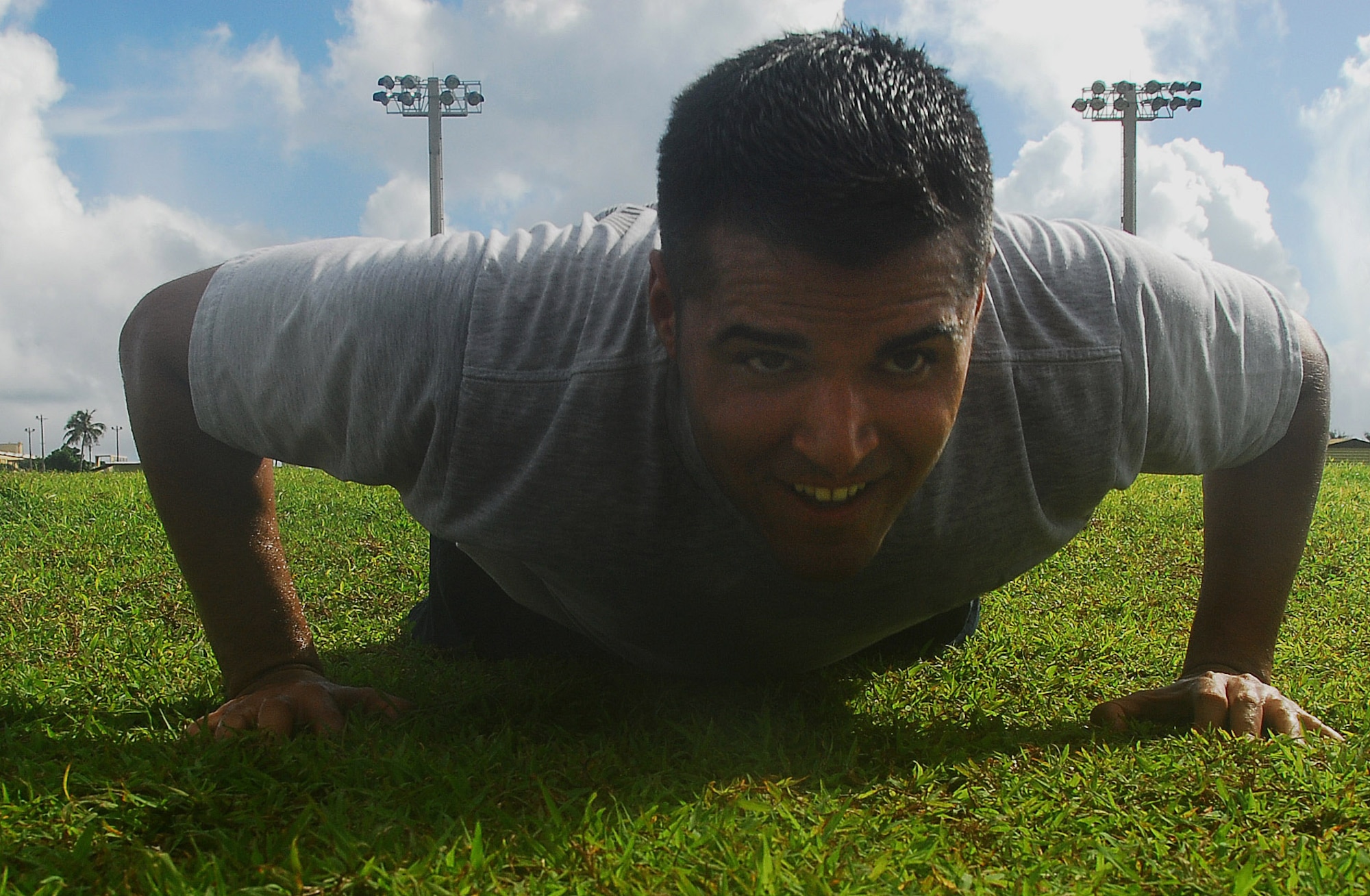 Staff Sgt. Louis Almaguer completes a correct push-up by lowering his body to the ground and making sure his elbows are bent at least 90 degrees or less before pushing back up to the starting position. The new fitness assesment allocates 60% for Aerobic (run or walk), 20% for abdominal circumference and 10% each for sit ups and pushups.  Sergeant Almaguer is  the NCO in charge of Construction Management with the 36th Civil Engineer Squadron.  (U.S. Air Force photo/Staff Sgt. Jamie Powell)

