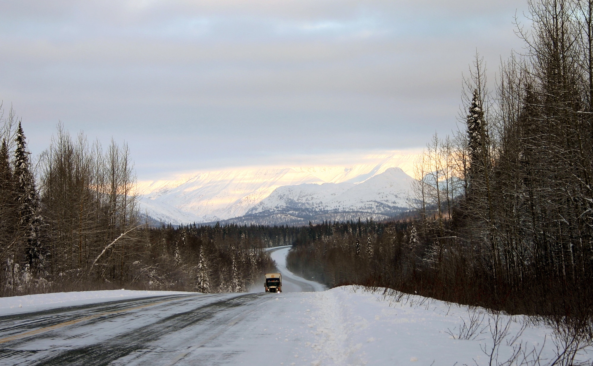 A truck winds it way along Alaska’s Parks Highway. Cold temperatures and icy roads require planning and preparation. (File photo)