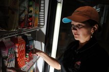 MINOT AIR FORCE BASE, N.D. -- Eugenia Bennett, wife of Staff Sgt. Anthony Bennett, 5th Contracting Squadron noncommissioned officer in charge mission support flight, organizes the supplies in the refrigerator at the Power Blendz smoothie bar located in the McAdoo Sports and Fitness Center here Oct. 14. The Power Blendz smoothie bar, which opened Sept. 27, makes meal replacement smoothies with additional supplements added as well as regular fruit smoothies. (U.S. Air Force photo by Airman 1st Class Aaron-Forrest Wainwright)