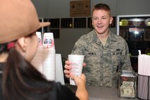 MINOT AIR FORCE BASE, N.D. -- Michelle Burney, wife of 2nd Lt. Tranton Burney, 740th Missile Squadron deputy combat crew commander, hands a smoothie to Senior Airman Jacob Hewitt, 91st Missile Security Forces Squadron security forces member, at the Power Blendz smoothie bar located in the McAdoo Sports and Fitness Center here Oct. 14. The Power Blendz smoothie bar, which opened Sept. 27, makes meal replacement smoothies with additional supplements added as well as regular fruit smoothies. (U.S. Air Force photo by Airman 1st Class Aaron-Forrest Wainwright)