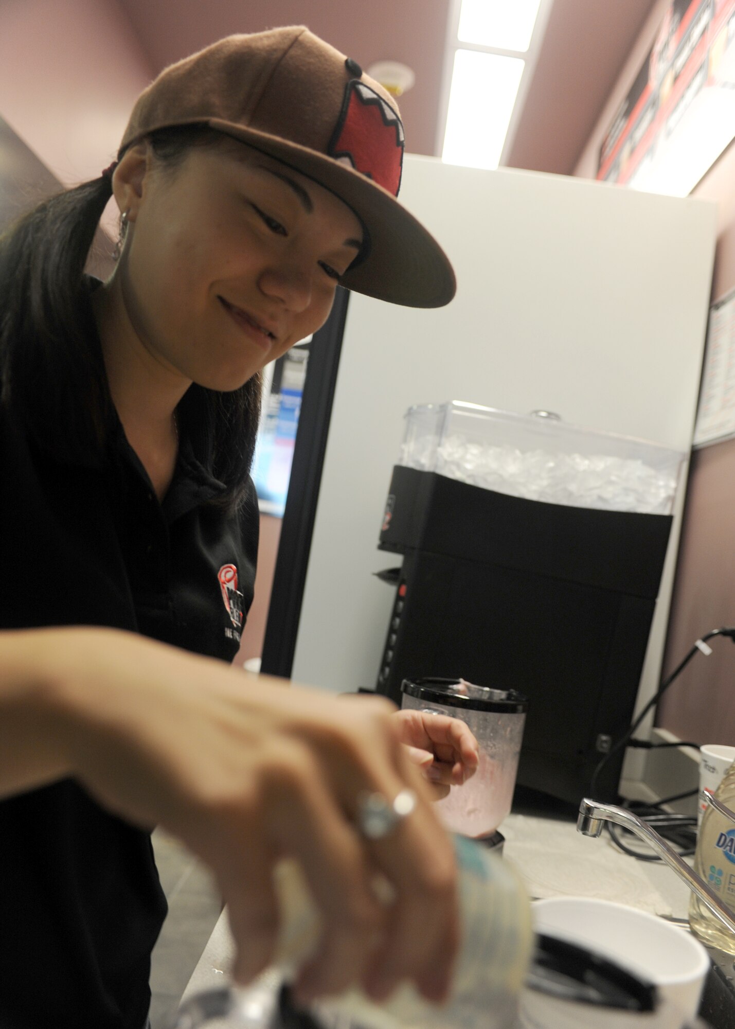 MINOT AIR FORCE BASE, N.D. -- Michelle Burney, wife of 2nd Lt. Tranton Burney, 740th Missile Squadron deputy combat crew commander, pours smoothie mixes together for a customer at the Power Blendz smoothie bar located in the McAdoo Sports and Fitness Center here Oct. 14. The Power Blendz smoothie bar at the fitness center opened on Sept. 27. They make smoothies with supplements to help out any work out regiments and regular fruit smoothies also. (U.S. Air Force photo by Airman 1st Class Aaron-Forrest Wainwright)