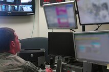MINOT AIR FORCE BASE, N.D. -- Airman 1st Class Michael Bates, 5th Civil Engineer Squadron alarm room operator, monitors incoming calls and makes notifications during an exercise here Oct. 20. The base will be testing its mass notification systems next week, including the emergency notification system, recall procedures, the base information hotline and public information sites such as the base website, social media pages and local television and radio stations. The test will help determine the most efficient ways to reach the majority of the base and local populations. (U.S. Air Force photo by Laurie Arellano)