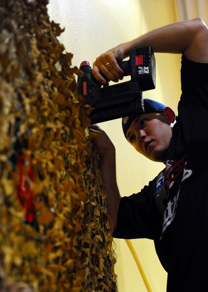 DYESS AIR FORCE BASE, Texas—Senior Airman Tyler Fitts, 7th Component Maintenance Squadron, decorates a wall for a haunted house Oct. 20 at the Dyess Youth Center here. Airmen from 7th Munitions Squadron hold a haunted house each year. This year it will be held Oct. 22-23rd from 6 to 11 p.m. at the Youth Center. (U.S. Air Force photo/ Airman 1st Class Brittney Smolinski)
