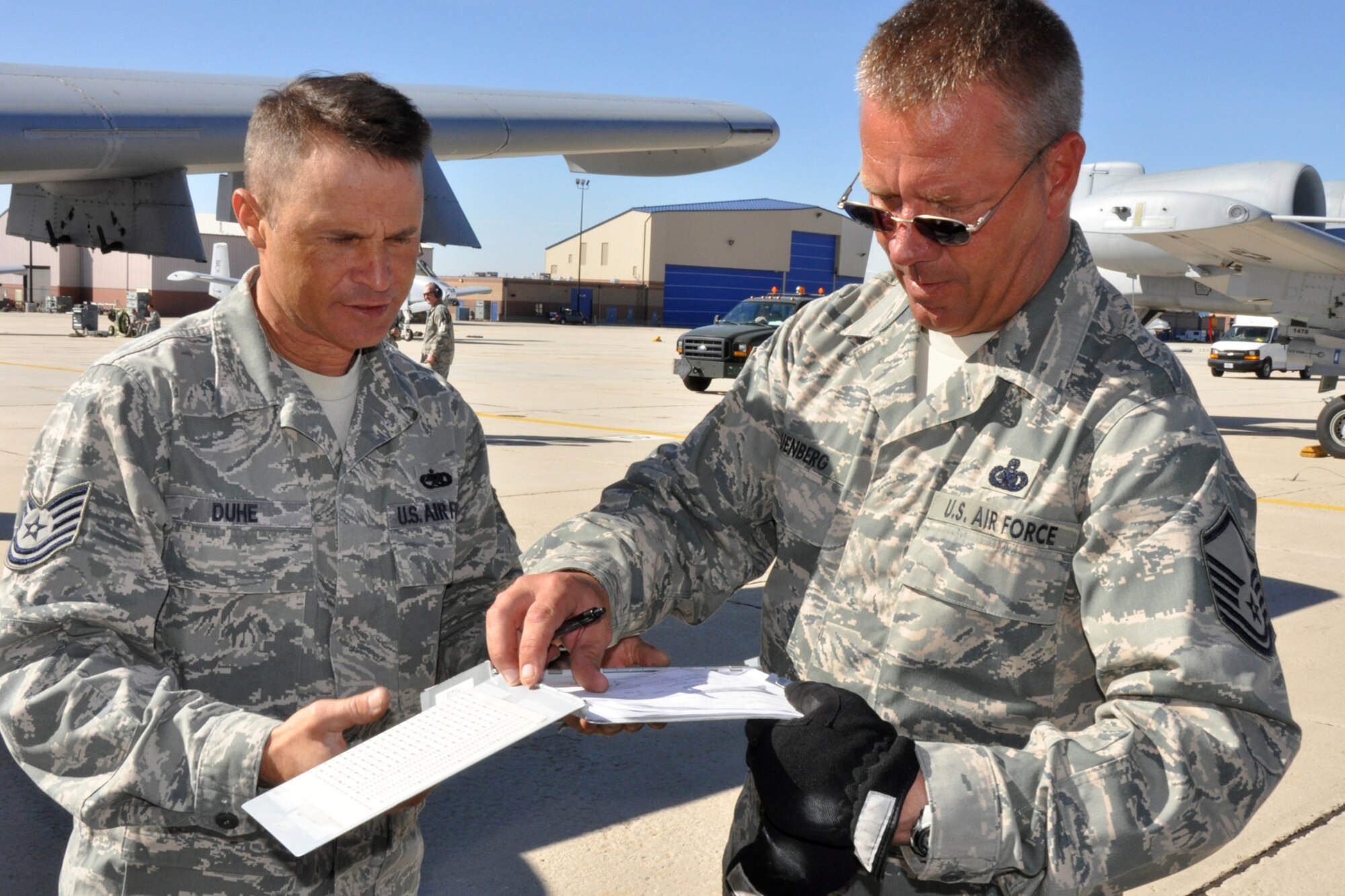 Technical Sgt Chris Duhe, a crew chief with the 717th Aircraft Maintenance Squadron, signs a fuels receipt from Master Sgt. Jeff Gruenberg, fuels accounting supervisor, 124th Logistics Refueling Flight on the ramp at Gowen Field, Boise, Idaho, Oct. 13, 2010. Members of the 917th Wing and 47th Fighter Squadron at Barksdale Air Force Base, La., were in Boise supporting and competing in Hawgsmoke 2010, which is a biennial worldwide A-10 bombing, missile and tactical gunnery competition. The competition this year, which involved 40 A-10 Thunderbolt II jets and 72 pilots from 18 different units, was hosted by the 190th Fighter Squadron of the 124th Fighter Wing, Idaho Air National Guard. (U.S. Air Force photo/Tech. Sgt. Jeff Walston) 

