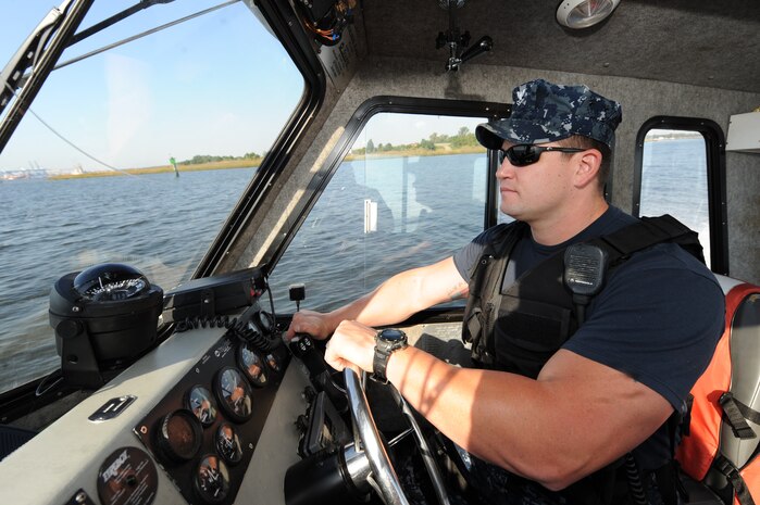 Master-at-Arms 2nd Class Nicholas Green steers a security boat while patrolling the waters of the Cooper River Oct. 19, 2010, on Joint Base Charleston-Weapons Station, S.C. MA2 Green and his team on the Weapons Station also provides land-based security for the entire Weapons Station. MA2 Green is a security forces member with the 628th Security Forces Squadron. ( U.S. Air Force photo/James M. Bowman)
