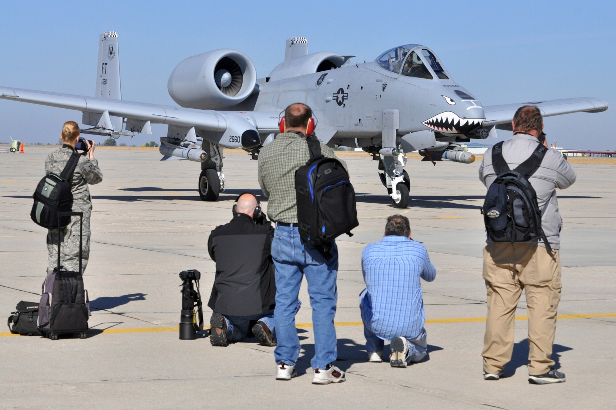 Representatives from local and national media outlets attempt to capture the perfect picture of an A-10 Thunderbolt on the ramp of Gowen Field in Boise, Idaho, Oct. 13, 2010. Members of the 917th Wing and 47th Fighter Squadron at Barksdale Air Force Base, La., were in Boise supporting and competing in Hawgsmoke 2010, which is a biennial worldwide A-10 bombing, missile and tactical gunnery competition. The competition this year, which involved 40 jets and 72 pilots from 18 different units, was hosted by the 190th Fighter Squadron of the 124th FW. (U.S. Air Force photo/Tech. Sgt. Jeff Walston) 