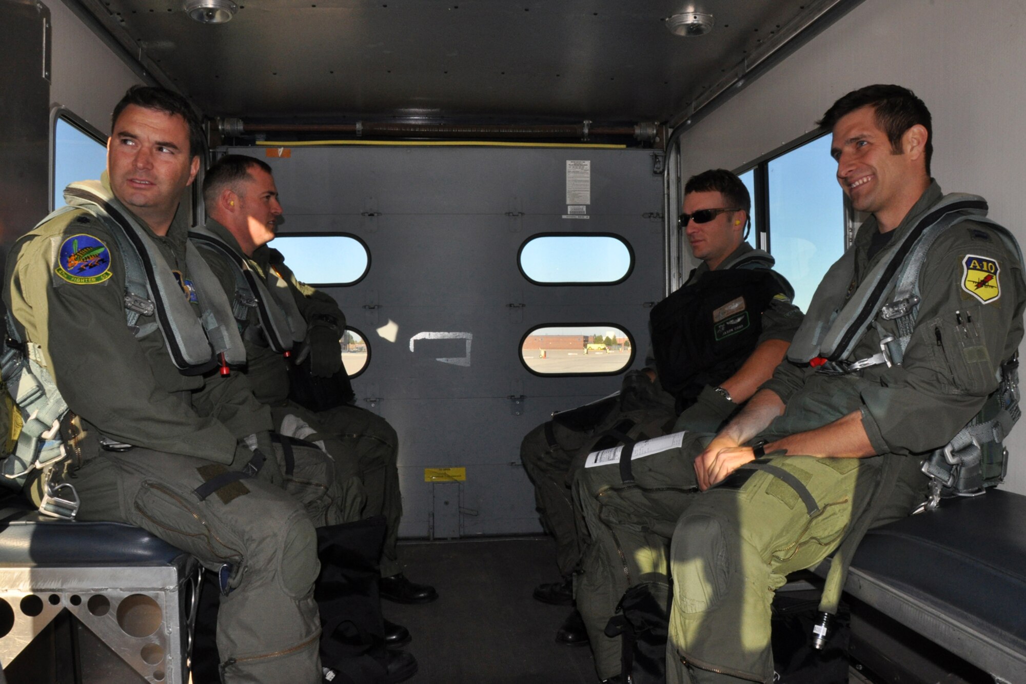 A-10 pilots Lt. Col. Robert Hetland, Capt. Adam Ratican, Capt. Jason Cobb and Capt. Grant McCall are transported to their jets for an orientation flight to prepare for Hawgsmoke 2010 competition in Boise, Idaho, Oct. 13, 2010. Members of the 917th Wing and 47th Fighter Squadron at Barksdale Air Force Base, La., were in Boise supporting and competing in Hawgsmoke 2010, which is a biennial worldwide A-10 bombing, missile and tactical gunnery competition. (U.S. Air Force photo/Tech. Sgt. Jeff Walston) 
   
