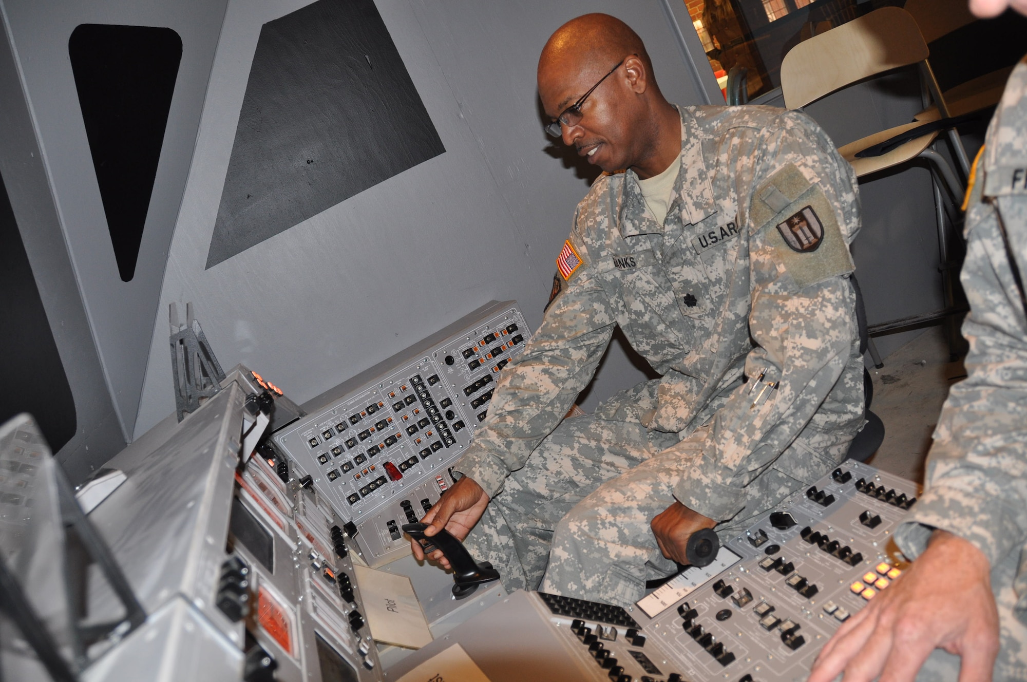 Lt. Col. Nathan Banks, Army Reserve public affairs, flys the Space Shuttle simulator at the Boy Scout Base Camp.(Air Force Photo/Paul Zadach)