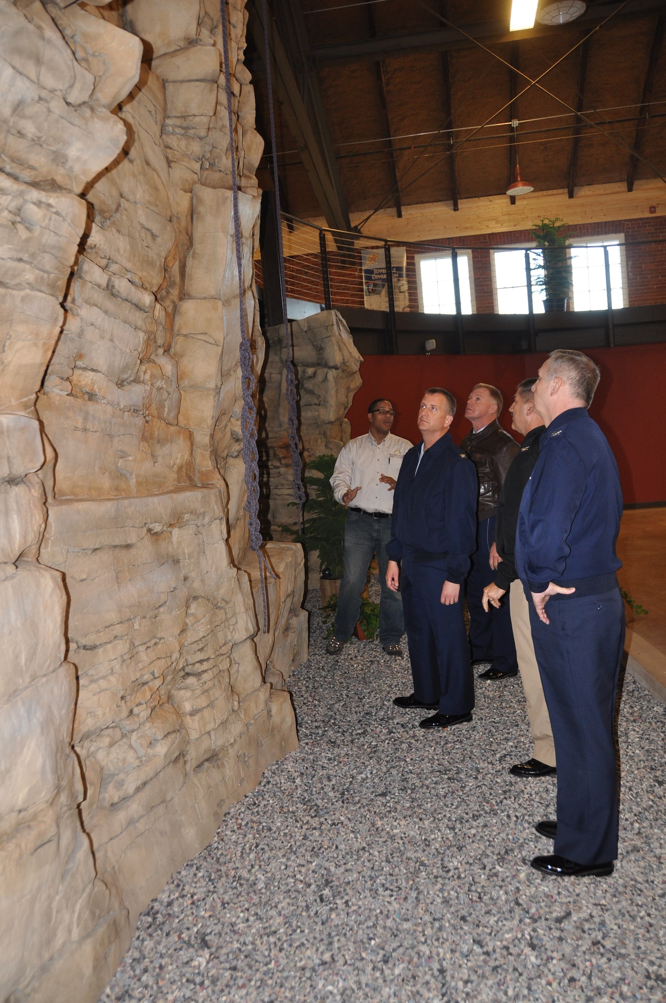 Jonathan Jones shows the rock climbing wall to Cols. Brett Newman and Ron Wilt, Capt. Kevin Hempel and Col. Mike Ochs survey at the Boy Scout Base Camp. (Air Force Photo/Paul Zadach)