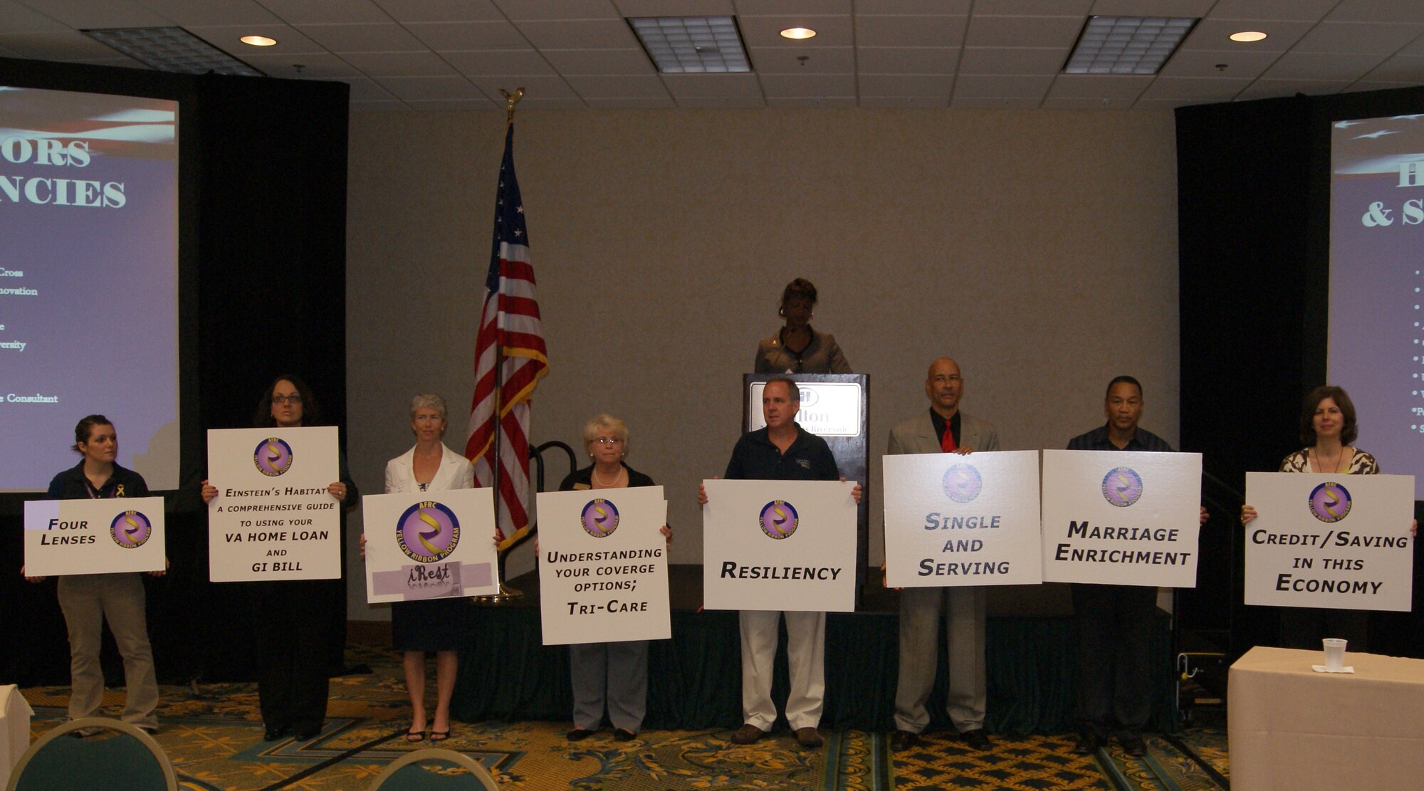 Yellow Ribbon staff members showcase the different options for sessions participants can attend at the first South Region Yellow Ribbon Program in New Orleans Oct. 16. The sessions focused on various aspects of Reservists’ lives affected by deployment including stress, communication, relationships, finances and more. (U.S. Air Force photo by Senior Airman Anna-Marie Wyant)