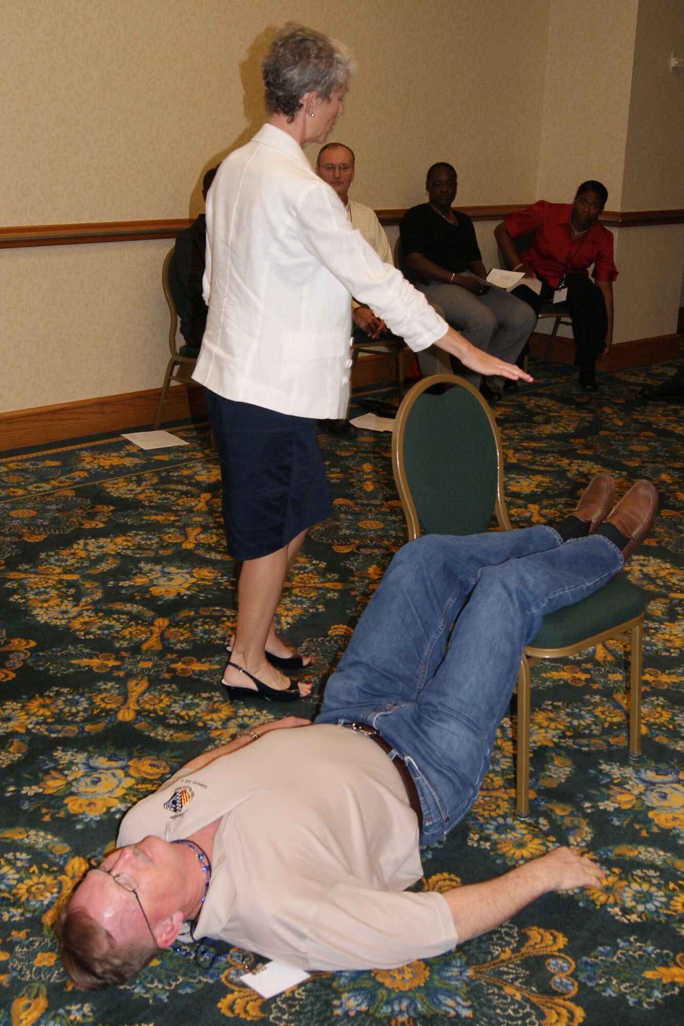 Chief Master Sgt. Clarence Tears, command chief, 482nd Fighter Wing, Homestead Air Reserve Base, Fla., helps demonstrate a comfortable relaxation position during the iRest-Restoration for Life session at the first South Region Yellow Ribbon Conference in New Orleans Oct. 16. The iRest session focused on practicing deep relaxation, breathing, healing negative emotions and restoring participants’ sense of well-being. (U.S. Air Force photo by Senior Airman Anna-Marie Wyant)