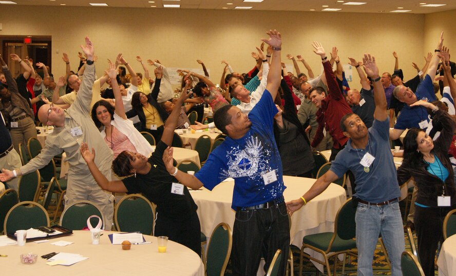 Reservists and family members do some energizing morning stretches at the first South Region Yellow Ribbon Program in New Orleans Oct. 16. The program, sponsored by Air Force Reserve Command, was designed to provide information, services, referral and proactive outreach programs to Reservists and Guardsmen and their dependents through all phases of deployment cycles. (U.S. Air Force photo by Senior Airman Anna-Marie Wyant)
