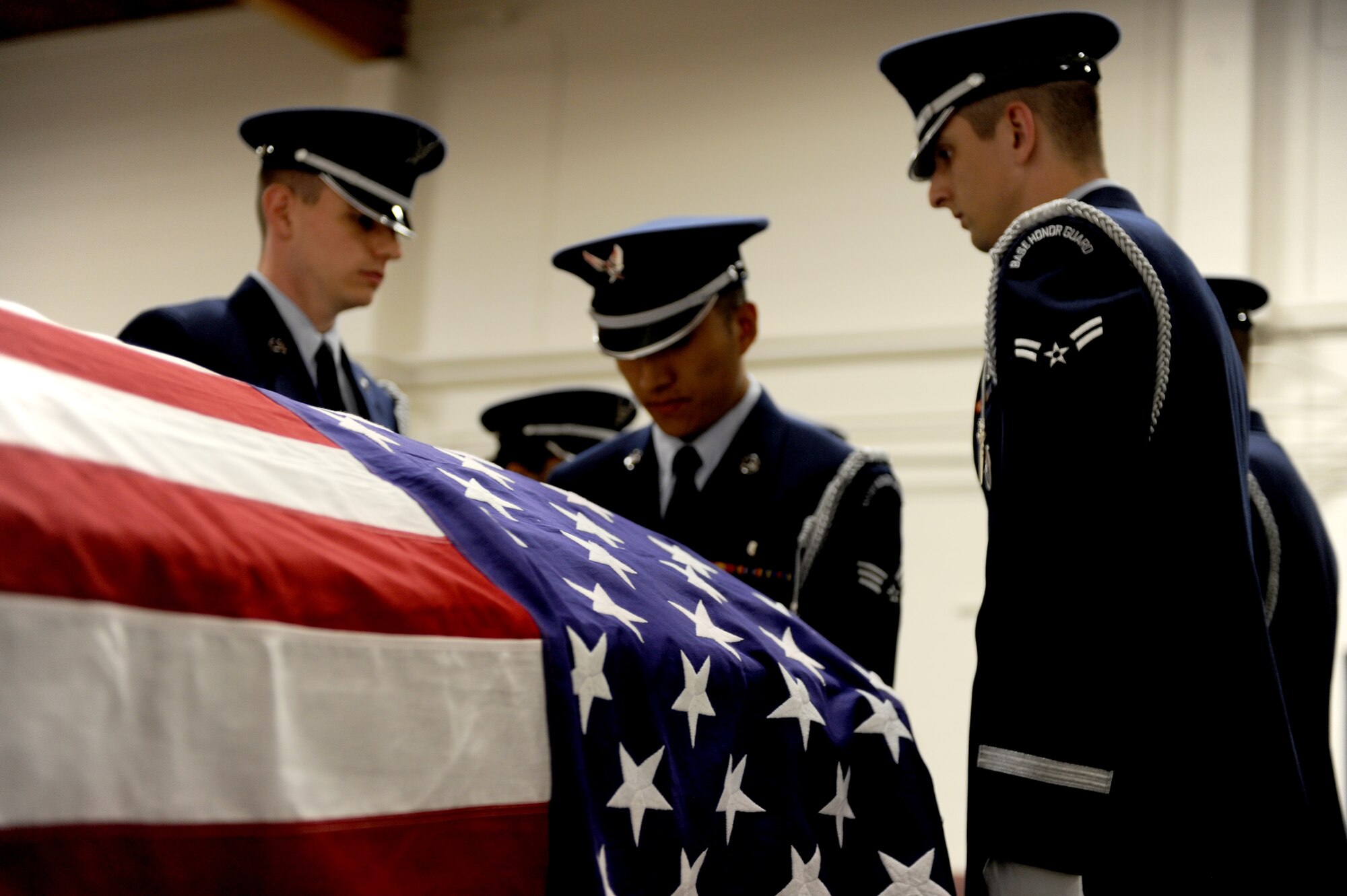 JEFFERSON BARRACKS, MO-- Members of the Scott Honor Guard practice draping a coffin with the American flag in preparation for a funeral Oct. 14..The Scott Air Force Base Honor Guard performs numerous details for Air Force veterans at this cemetery as well as covering funerals throughout a four state region. Airmen of all ranks and units are assigned to the Honor Guard for four months at a time. (U.S. Air Force photo/ Staff Sgt. Brian Valencia)