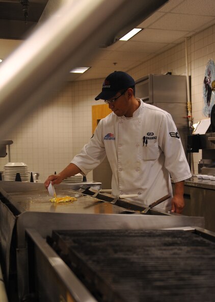 DYESS AIR FORCE BASE, Texas --Airman 1st Class Michael Hernandez, 7th Force Support Squadron services specialist, fries eggs for an Airman at the Longhorn Dining Facility here Oct. 20. The mission of the 7 FSS is to develop, sustain and regenerate people through first-class customer service, the first time and every time. For the dining facility hours of operation, logon to http://www.dyessfss.com/Food_Service.html or call (325) 696-2421. (U.S. Air Force photo/ Senior Airman Felicia Juenke)