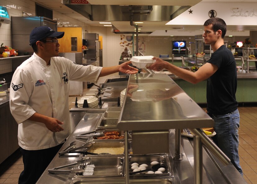 DYESS AIR FORCE BASE, Texas -- Airman 1st Class Michael Hernandez, 7th Force Support Squadron services specialist, prepares breakfast for an Airman at the Longhorn Dining Facility here Oct. 20. The mission of the 7 FSS is to develop, sustain and regenerate people through first-class customer service, the first time and every time. For the dining facility hours of operation, logon to http://www.dyessfss.com/Food_Service.html or call (325) 696-2421. (U.S. Air Force photo/ Senior Airman Felicia Juenke)
