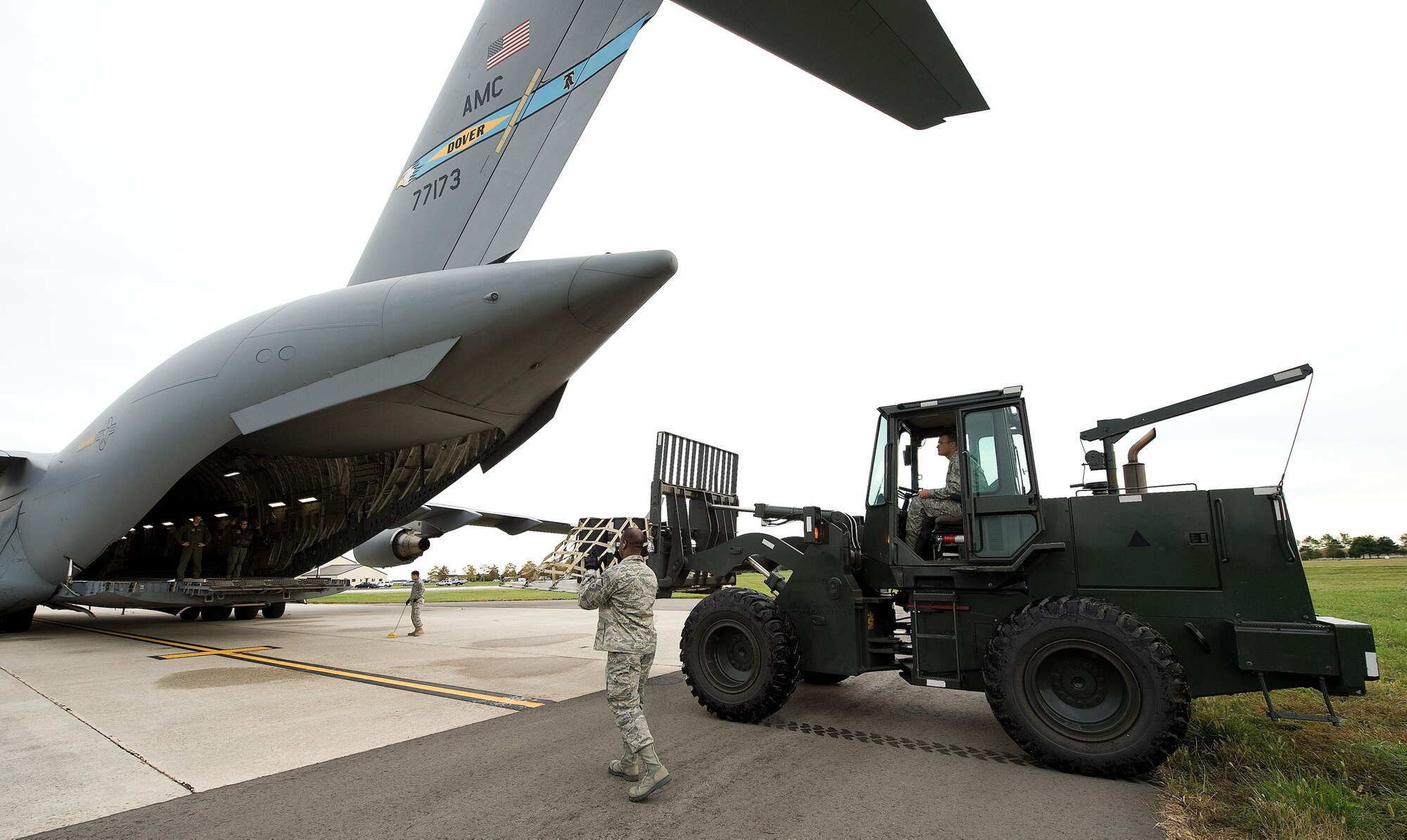 Members of the 3rd Airlift Squadron and 436th Aerial Port Squadron, load
simulated radioactive material during an exercise Oct. 14, 2010, on Dover
Air Force Base, Del. The exercise was a simulated hard landing after a bird
strike followed by a radioactive material leak.  (U.S. Air Force photo by
Jason Minto/Released)
