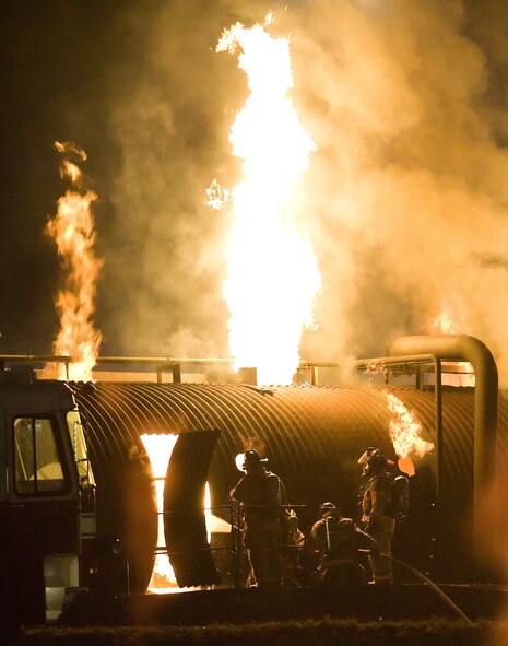 Dover Air Force Base and City of Dover firefighters work to put out asimulated aircraft fire during a live fire exercise Oct. 19, 2010, at thefire training area on Dover AFB, Del. The exercise is one of severalexercises completed at Dover AFB this year, in which Dover AFB firefighterswork in tandem with City of Dover firefighters their mutual aid partners.(U.S. Air Force photo by Jason Minto/Released)