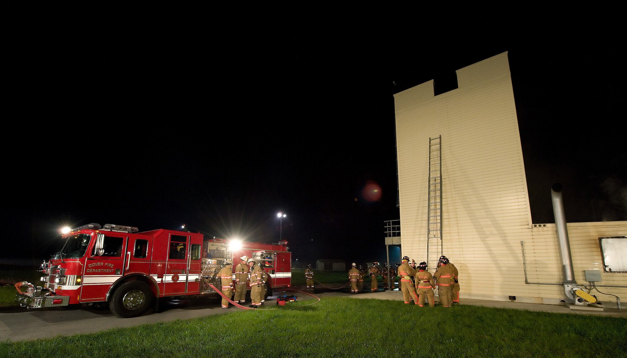 Dover Air Force Base and City of Dover firefighters prepare for a
simulated building fire exercise during a live fire exercise Oct. 19, 2010,
at the fire training area on Dover AFB, Del. This exercise was one of
several semi-annual exercises that Dover AFB has done this year with the
assistance of the City of Dover, who often train with 436th CES firefighters
on these exercises. (U.S. Air Force photo by Jason Minto/Released)
