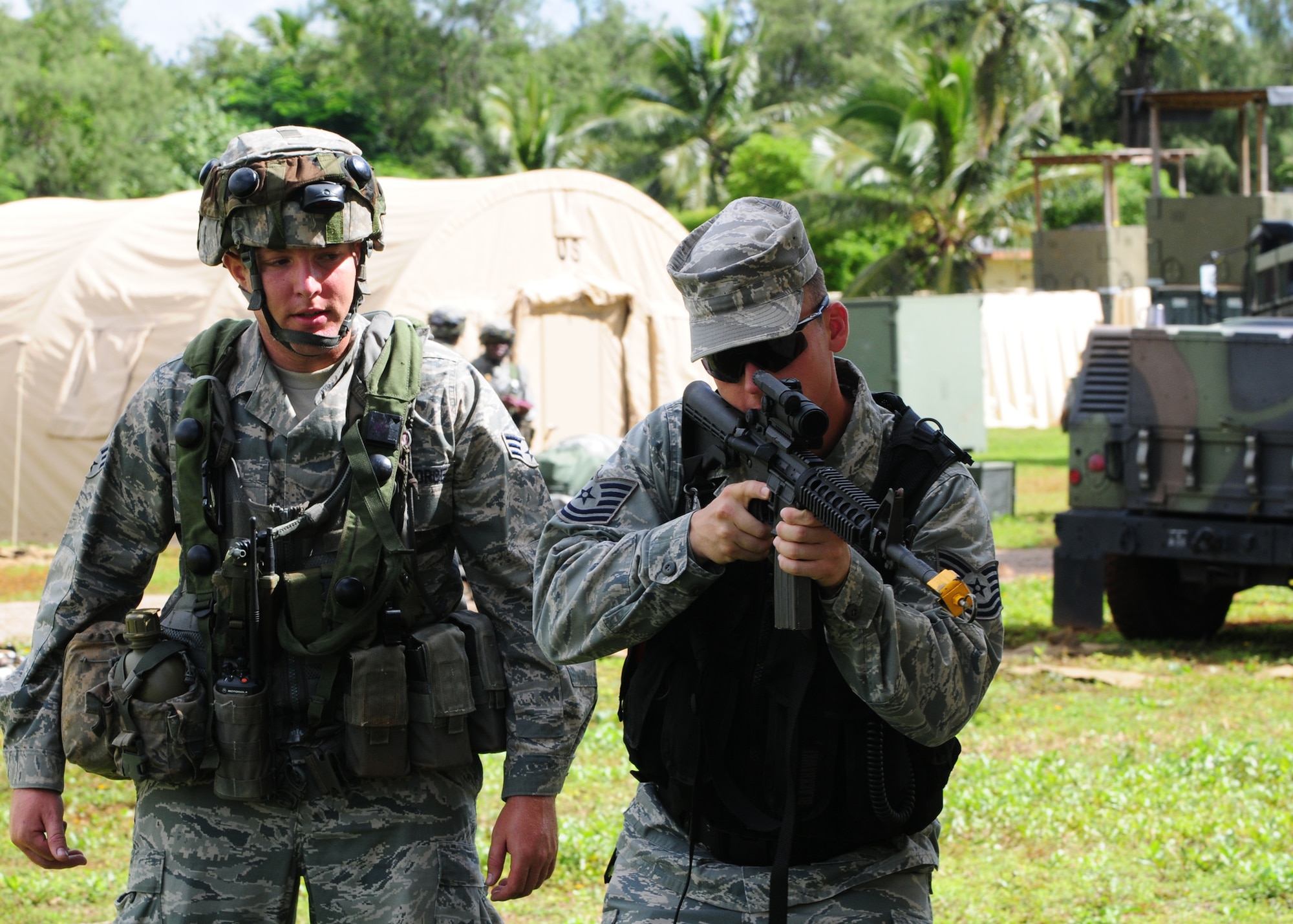 Tech. Sgt. William McGee, 644th Combat Communications Squadron, Combat Readiness School cadre shows Senior Airman Scott Erwin, 644th CBCS deployed network communications center technician, how to properly retreat from enemy fire during a training scenario at Andersen Air Force Base, Guam, Oct.  19. Andersen Airmen teamed up with members of the RAAF for a 20-day Combat Readiness School at Andersen South training base to teach the Airmen new tactics and act as a refresher course for those who were already familiar with the training. (U.S. Air Force photo/ Senior Airman Nichelle Anderson)