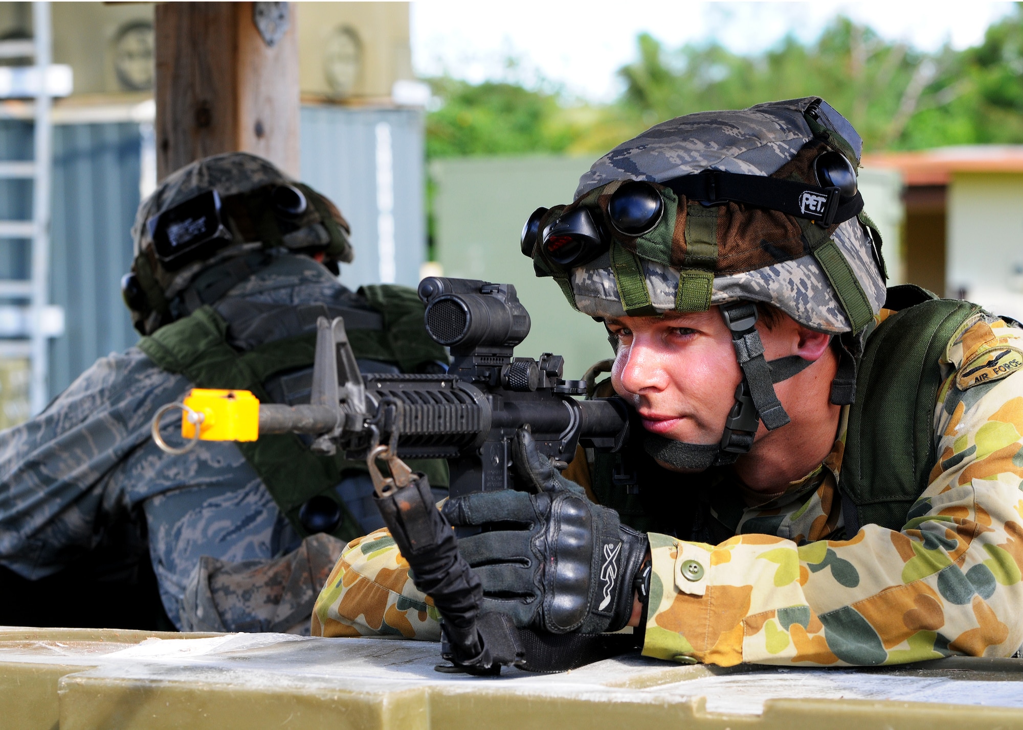 Lead Aircraftmen Matthew Brougham, 1 Combat Communications Squadron, Royal Australian Air Force Base, Richmond, Sydney, scans the perimeter in a defensive fighting position during the field training exercise portion of Combat Readiness School at Andersen Air Force Base, Guam Oct. 19. (U.S. Air Force photo/ Senior Airman Nichelle Anderson)