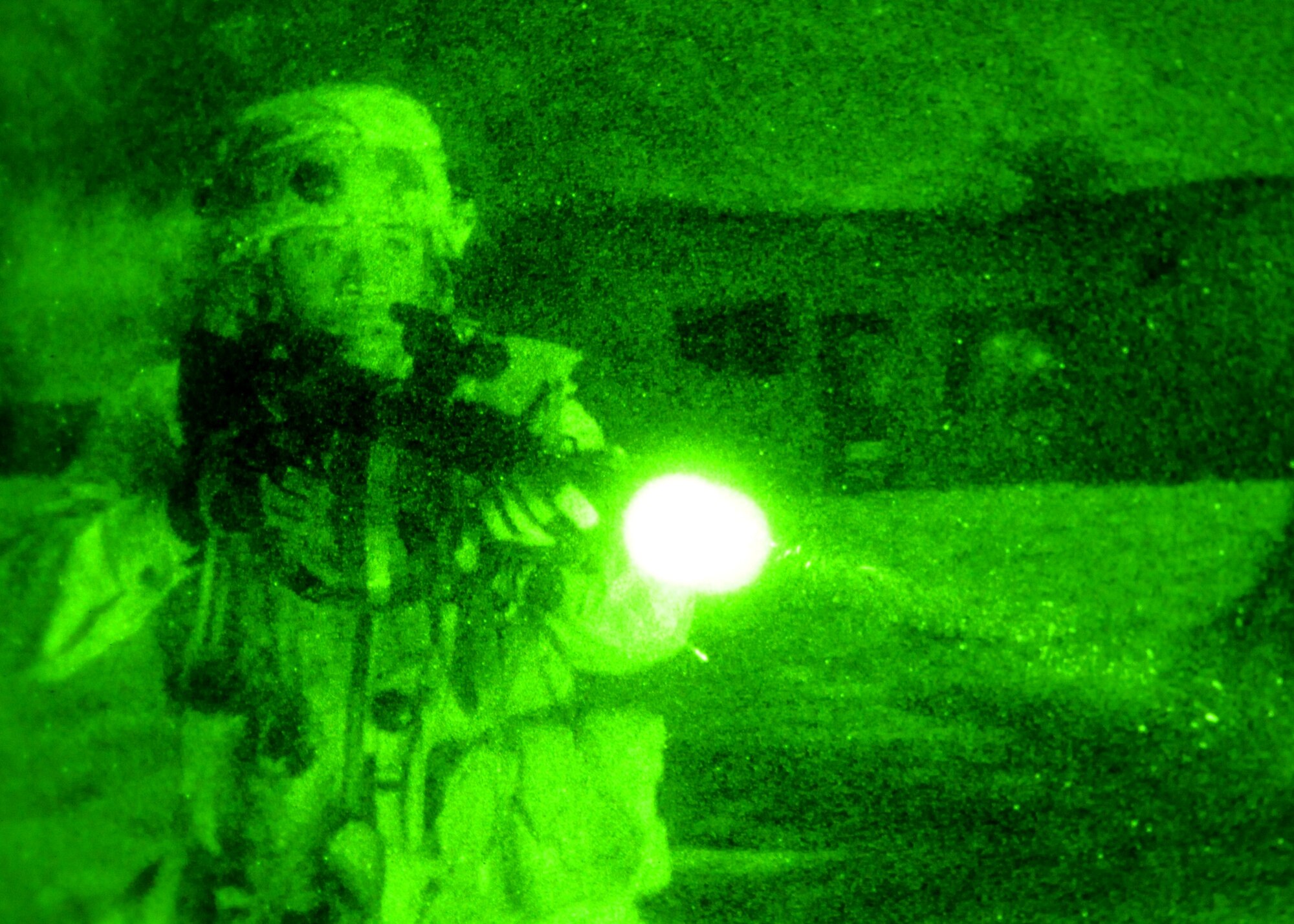 An Airman from the 644th Combat Communications Squadron approaches a defensive fighting position to simulate the search and recovery of a member of the opposing force killed in action during a training scenario at Andersen Air Force Base, Guam Oct. 18. The scenario was one of many during a multi-day field training exercise at Andersen South where students put to use what they?ve learned during the 20-day Combat Readiness Course. (U.S. Air Force photo/ Senior Airman Nichelle Anderson)