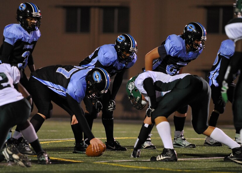 Osan American High School football players prepare for a snap against Daegu American High School defenders Oct. 15 at Osan Air Base.  The OAHS Cougars fell short 28-6 but will host their final and homecoming game Oct. 29. (U.S. Air Force Photo/Senior Airman Evelyn Chavez)