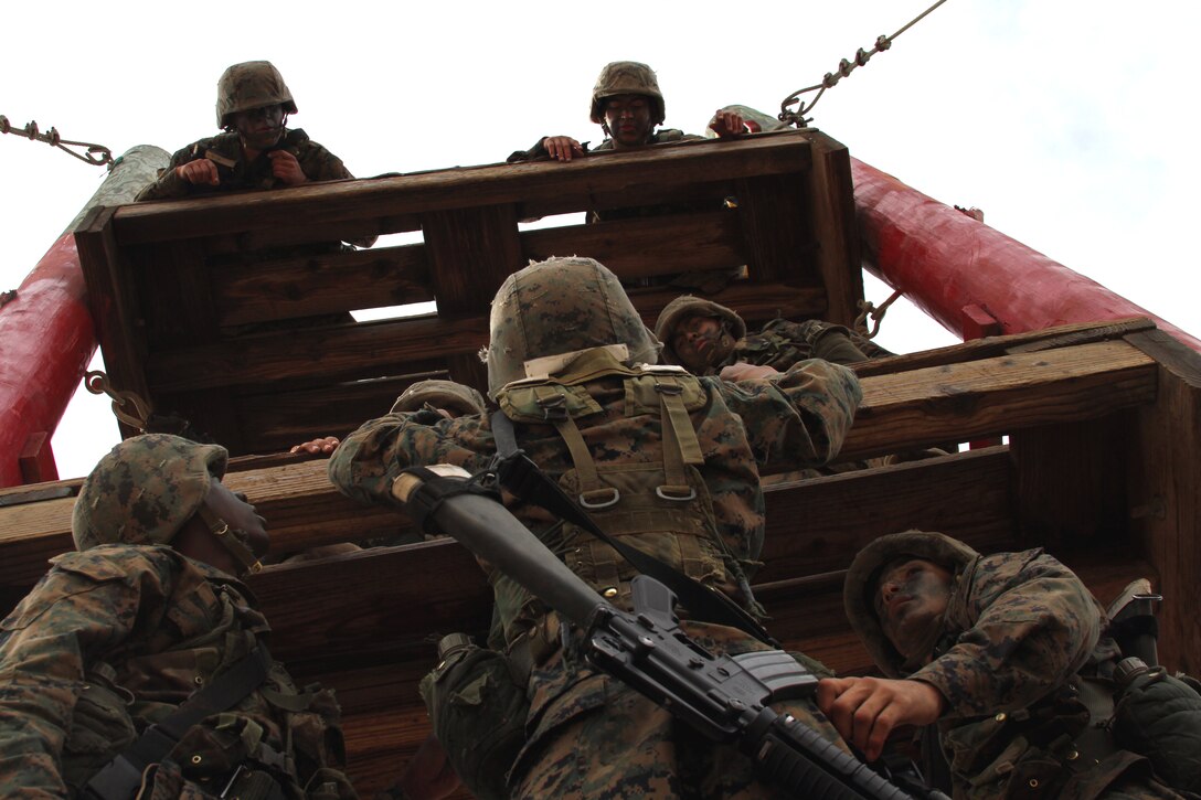 Members of Platoon 1085, Company D climb an obstacle as  part of the Confidence Course during the Crucible. The Crucible is a 54-hour training event conducted during Marine Corps Recruit Training at Edson Range, Marine Corps Base Camp Pendleton, Calif. The Crucible requires Marine recruits to overcome mentally and physically-demanding obstacles as a team.