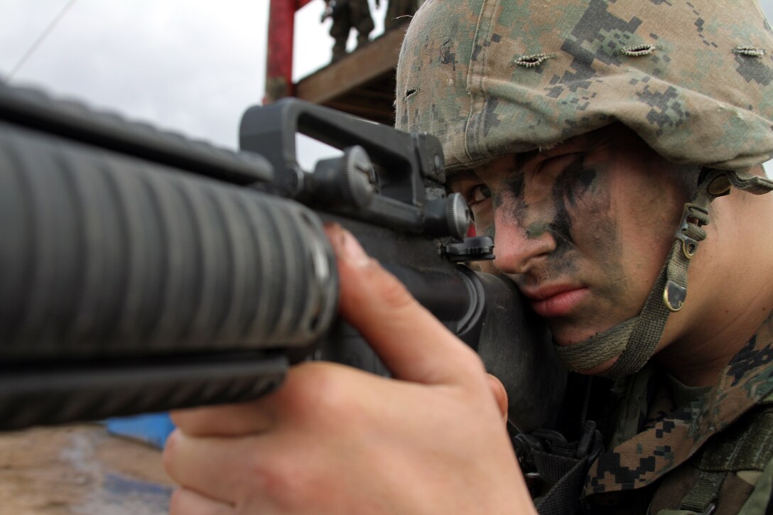 Recruit Patrick Garza takes aim while providing security during an event of the Crucible. The Crucible is a 54-hour training event conducted during Marine Corps Recruit Training at Edson Range, Marine Corps Base Camp Pendleton, Calif. The Crucible requires Marine recruits to overcome mentally and physically-demanding obstacles as a team.::r::::n::Garza is a member of Platoon 1085, Company D. ::r::::n::